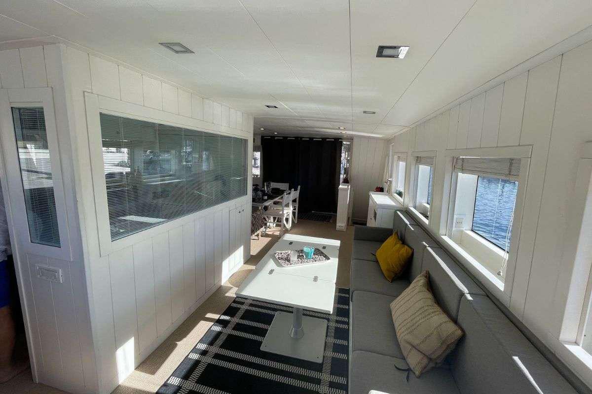 a room with a table and chairs aboard FLAMENGA Yacht for Charter