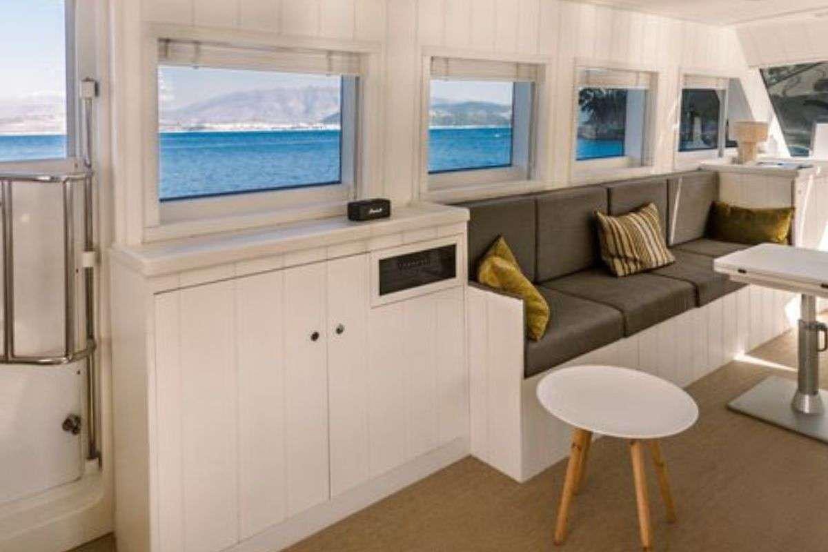a small living room with a couch and a television aboard FLAMENGA Yacht for Charter