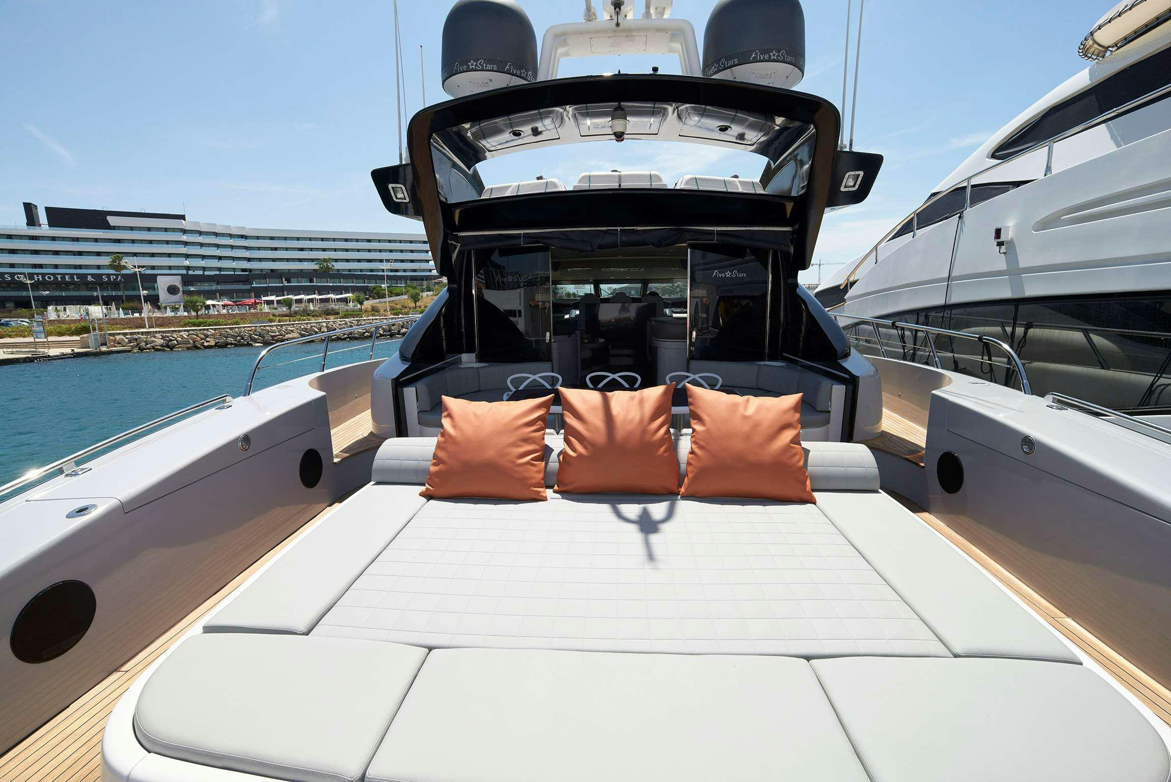 a boat with orange pillows on the deck aboard FIVE STARS Yacht for Charter