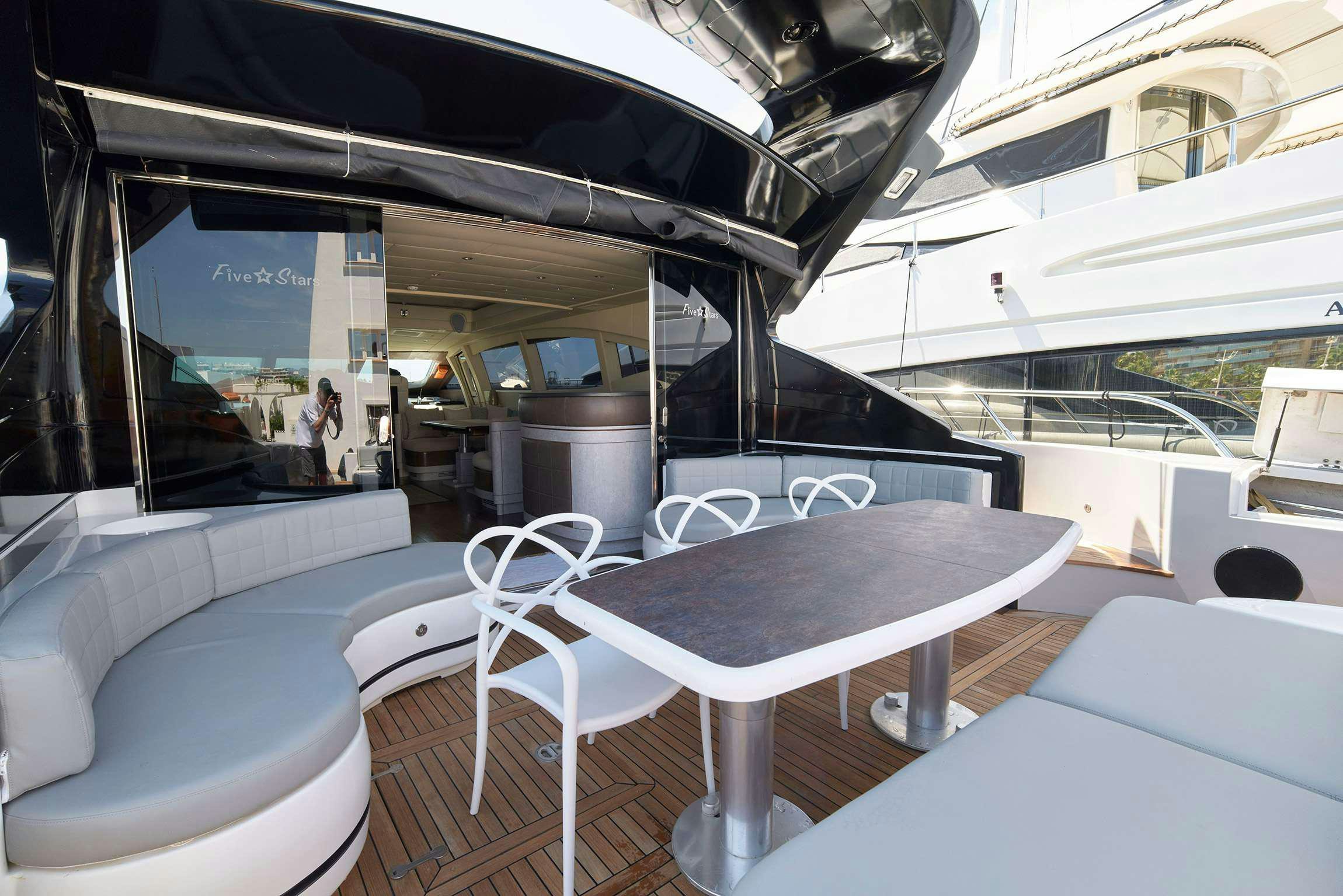 a table and chairs on a boat aboard FIVE STARS Yacht for Charter