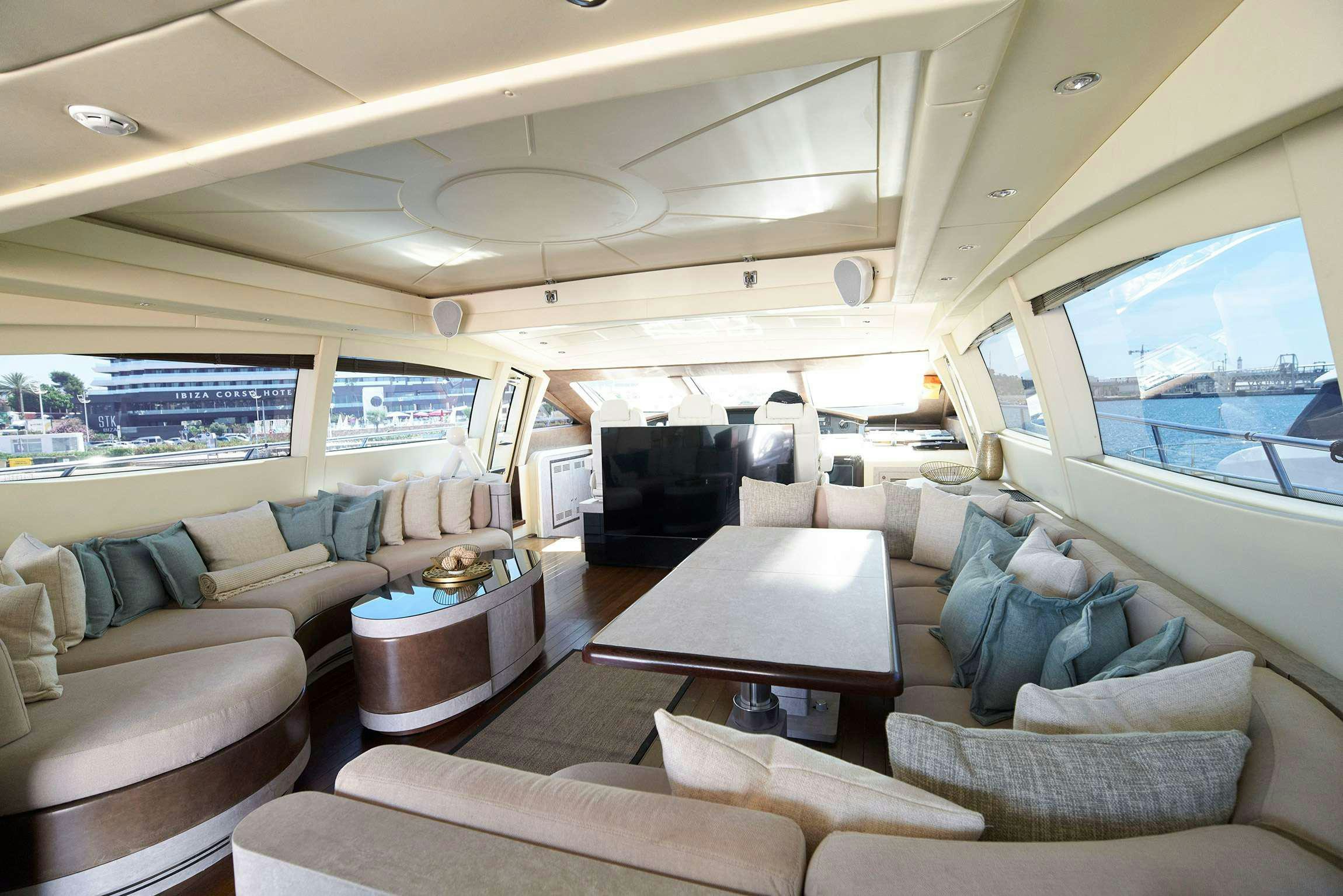 a living room with a large window aboard FIVE STARS Yacht for Charter