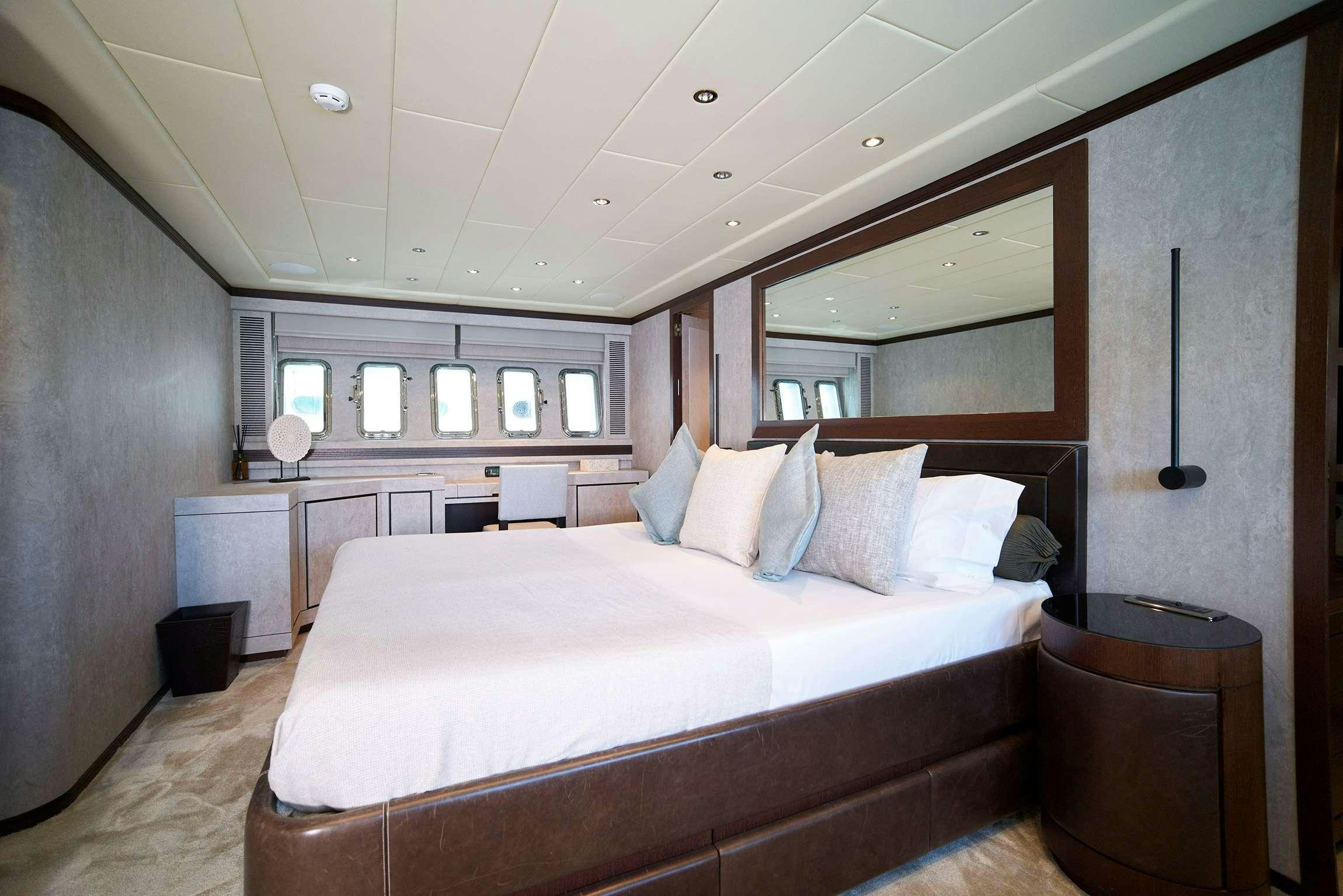 a large bed in a room aboard FIVE STARS Yacht for Charter