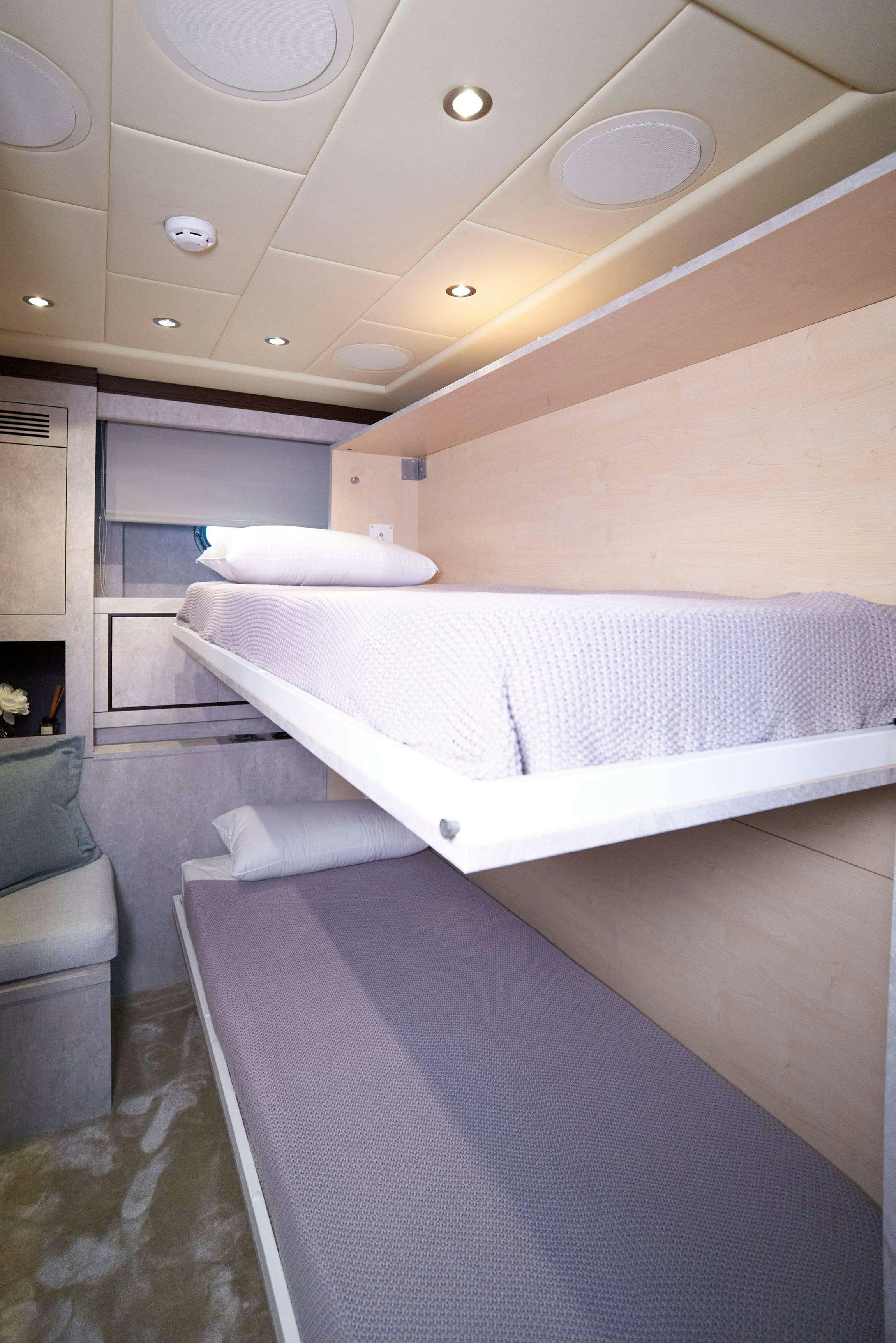 a room with a bed and a couch aboard FIVE STARS Yacht for Charter