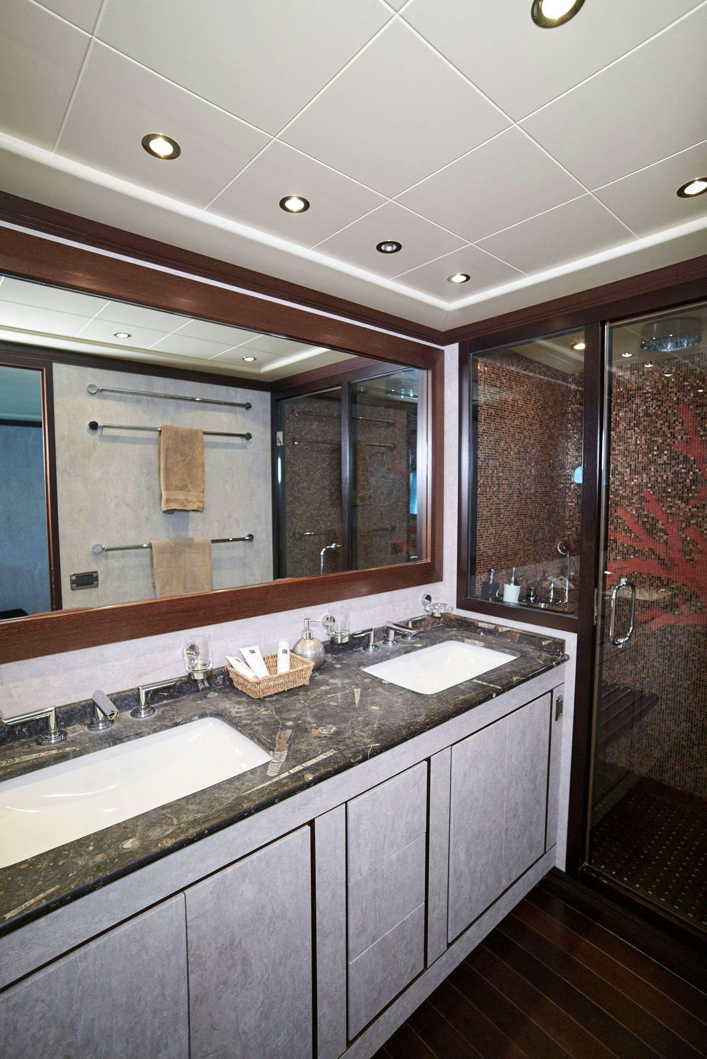 a bathroom with a large mirror aboard FIVE STARS Yacht for Charter
