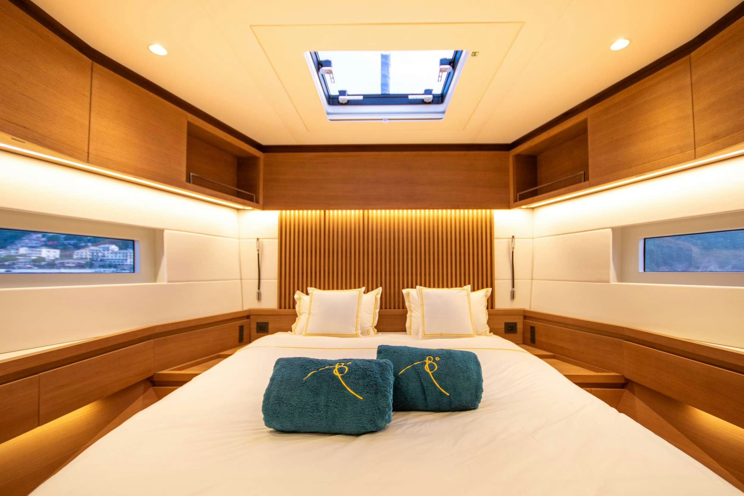 a bed with pillows on it aboard BIANCA Yacht for Charter