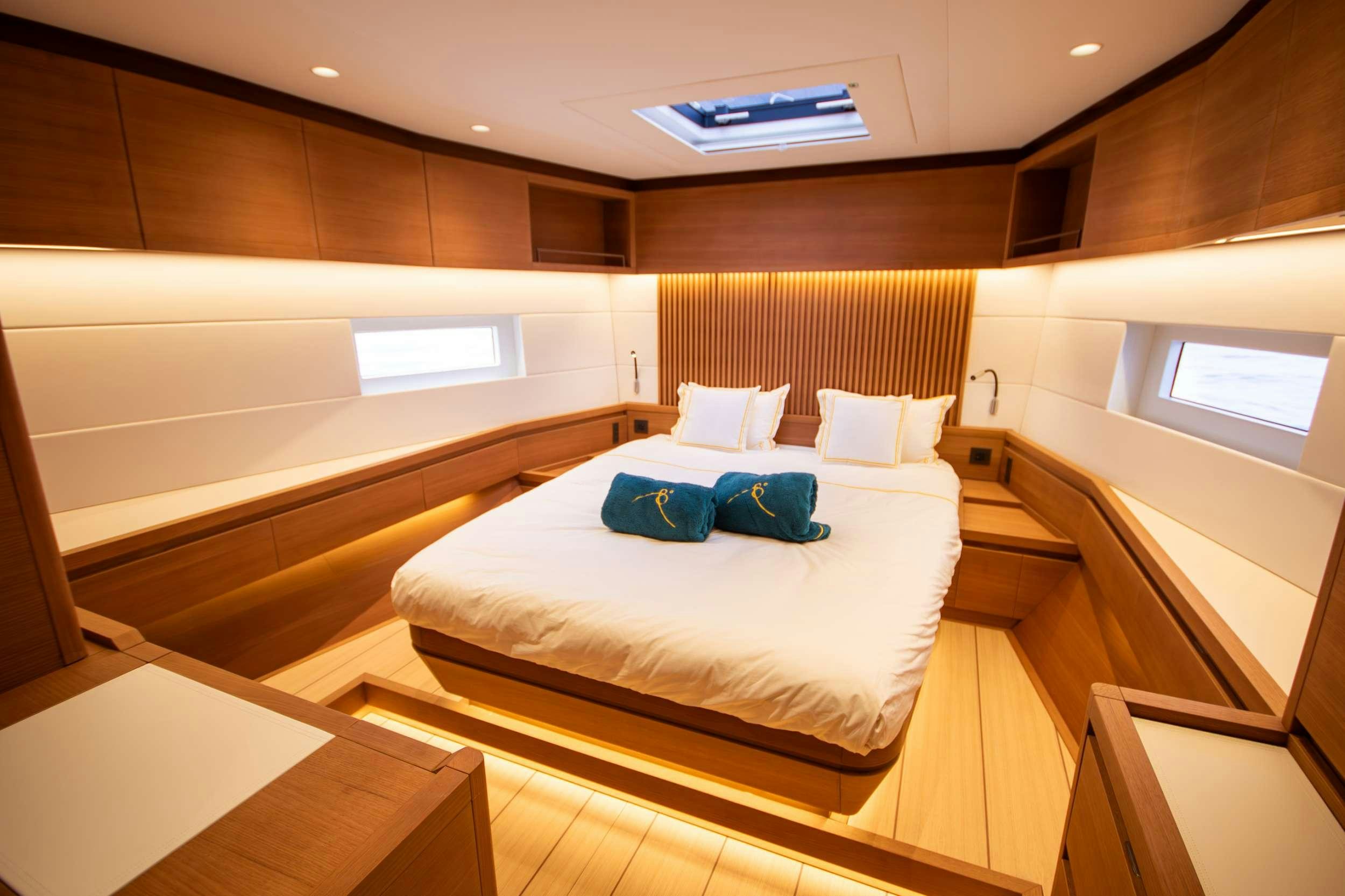 a room with a bed and a desk aboard BIANCA Yacht for Charter