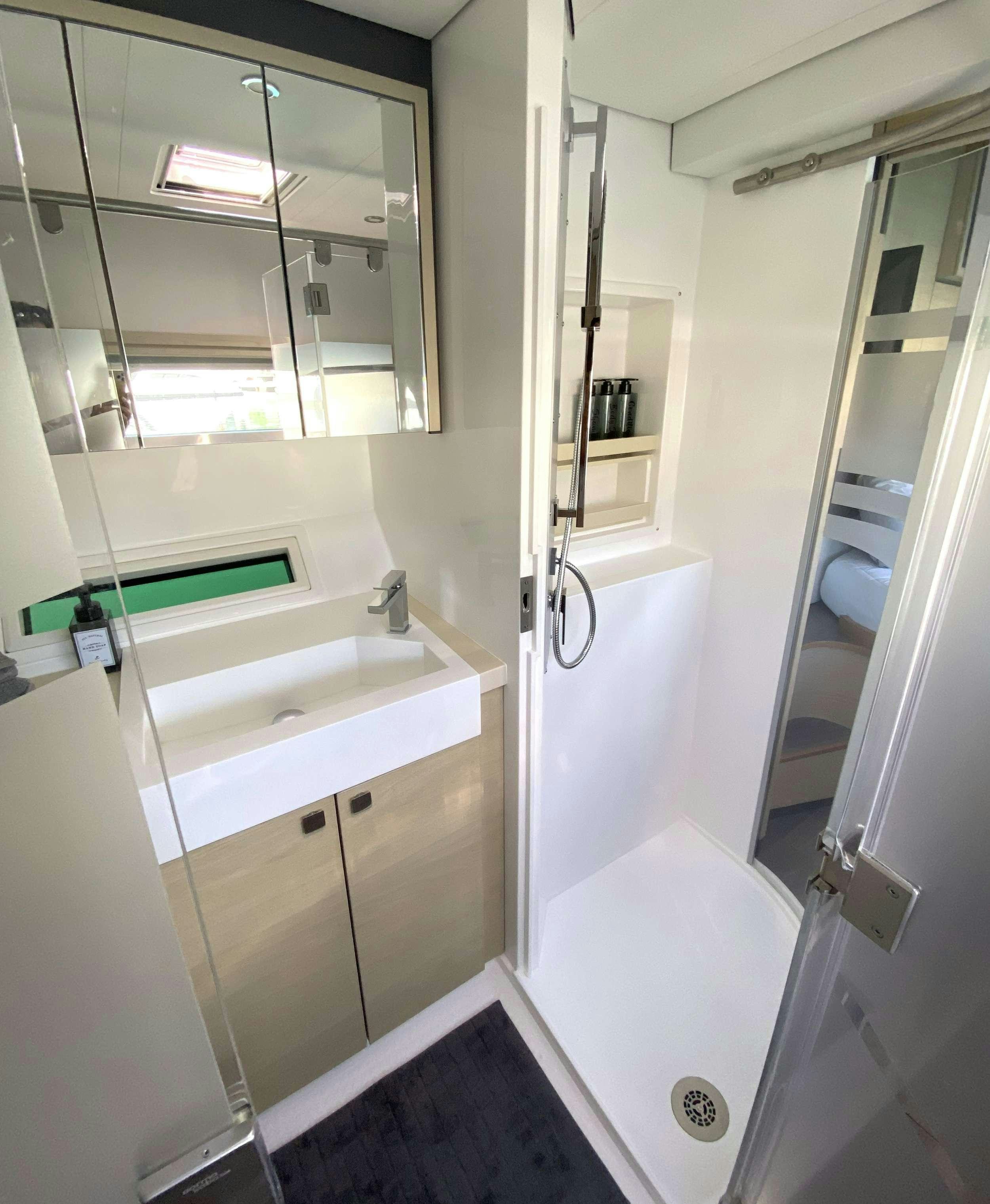 a bathroom with a tub sink and mirror aboard WEIHAII Yacht for Charter
