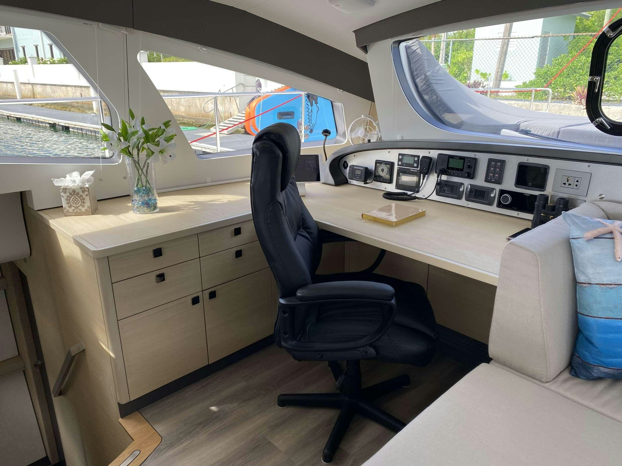 a room with a desk and a chair aboard WEIHAII Yacht for Charter