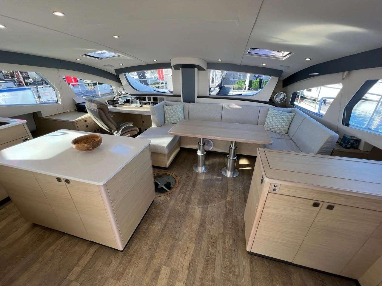 a room with a large white table and chairs aboard WEIHAII Yacht for Charter