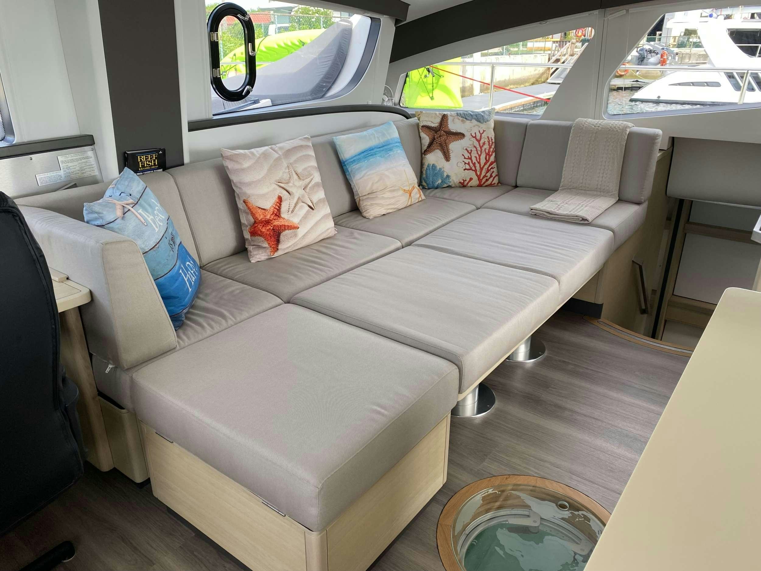 a couch with a pillow on it aboard WEIHAII Yacht for Charter