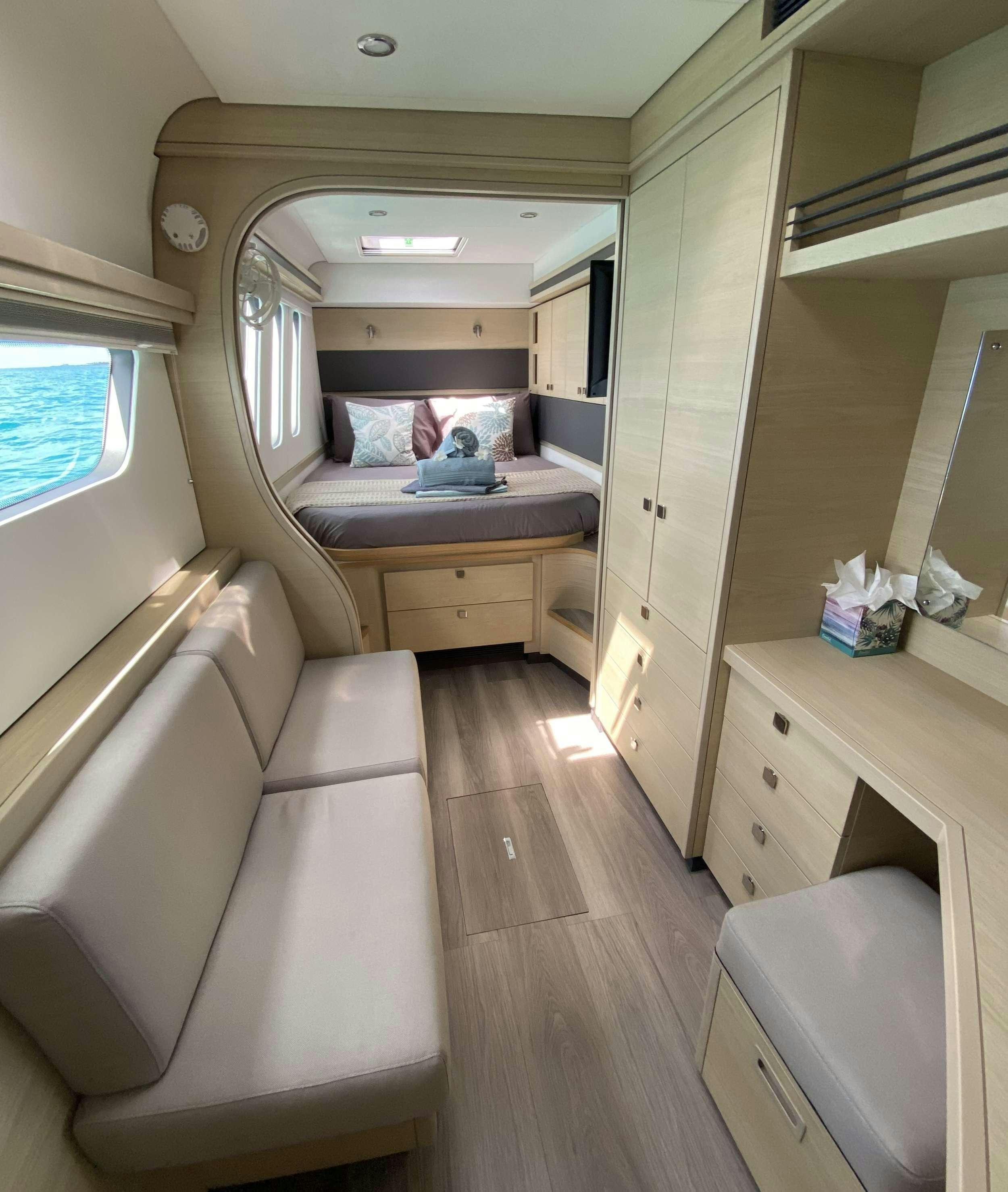 a small bedroom with a bed aboard WEIHAII Yacht for Charter