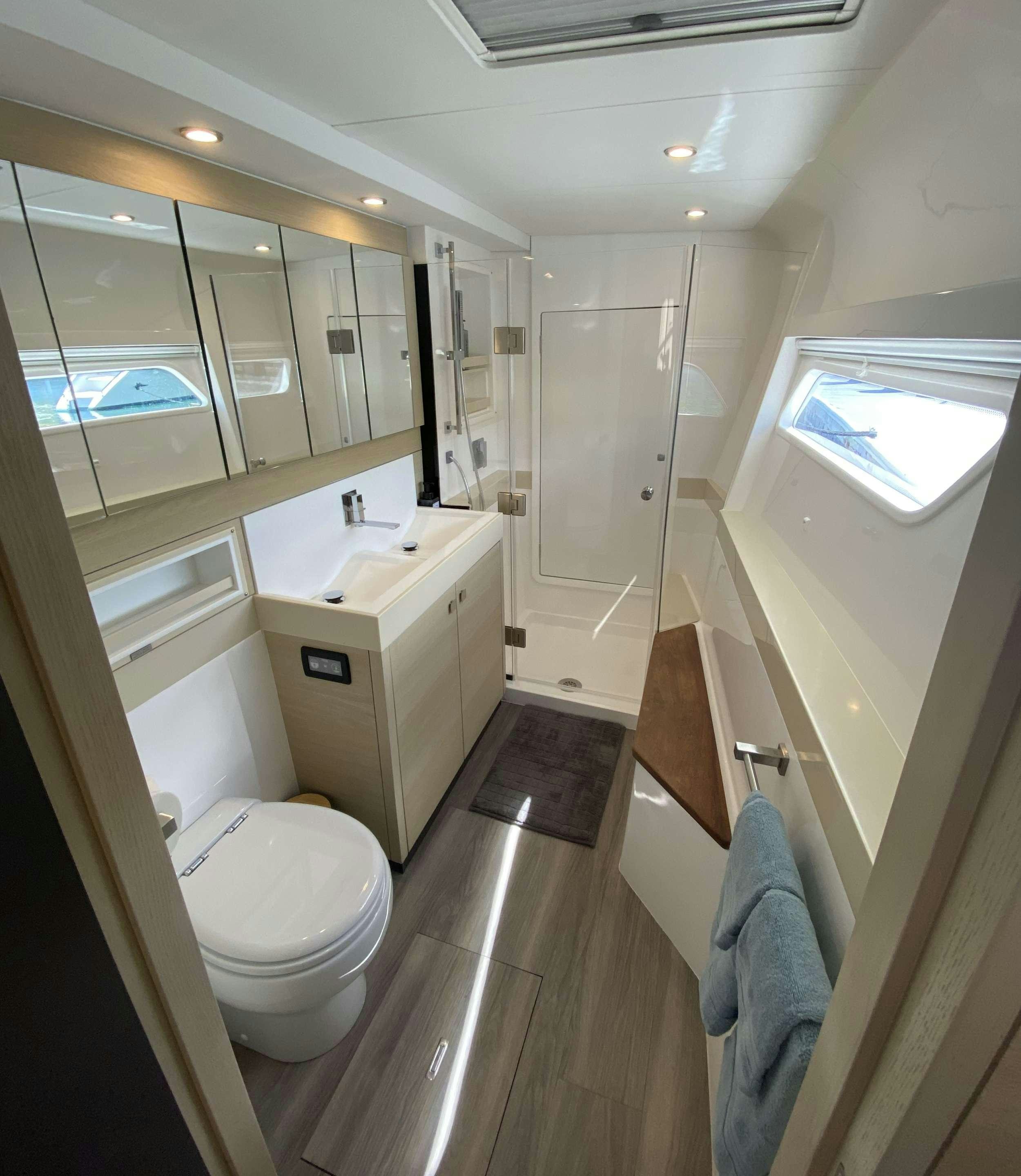 a bathroom with a large mirror aboard WEIHAII Yacht for Charter