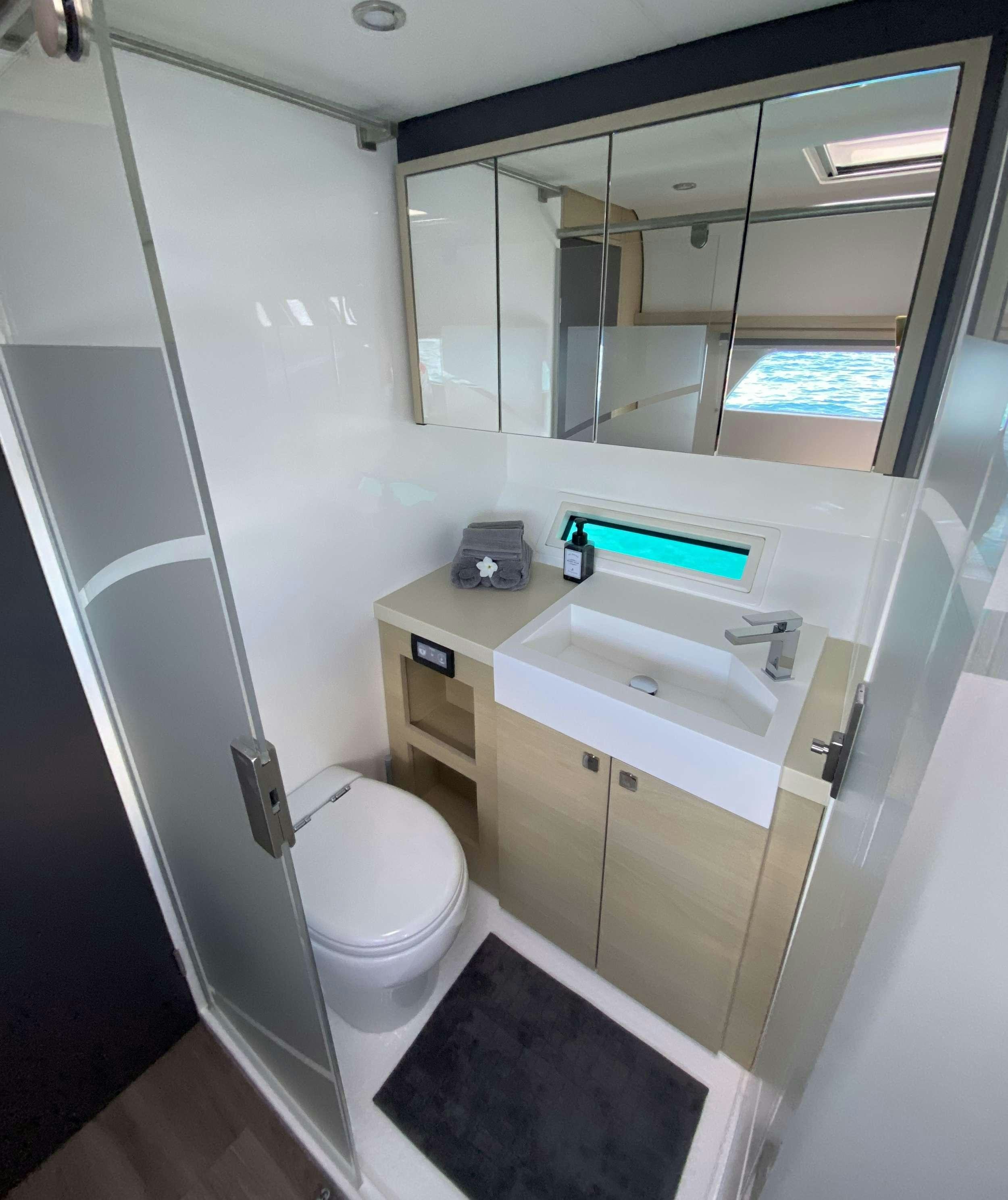 a bathroom with a large mirror aboard WEIHAII Yacht for Charter