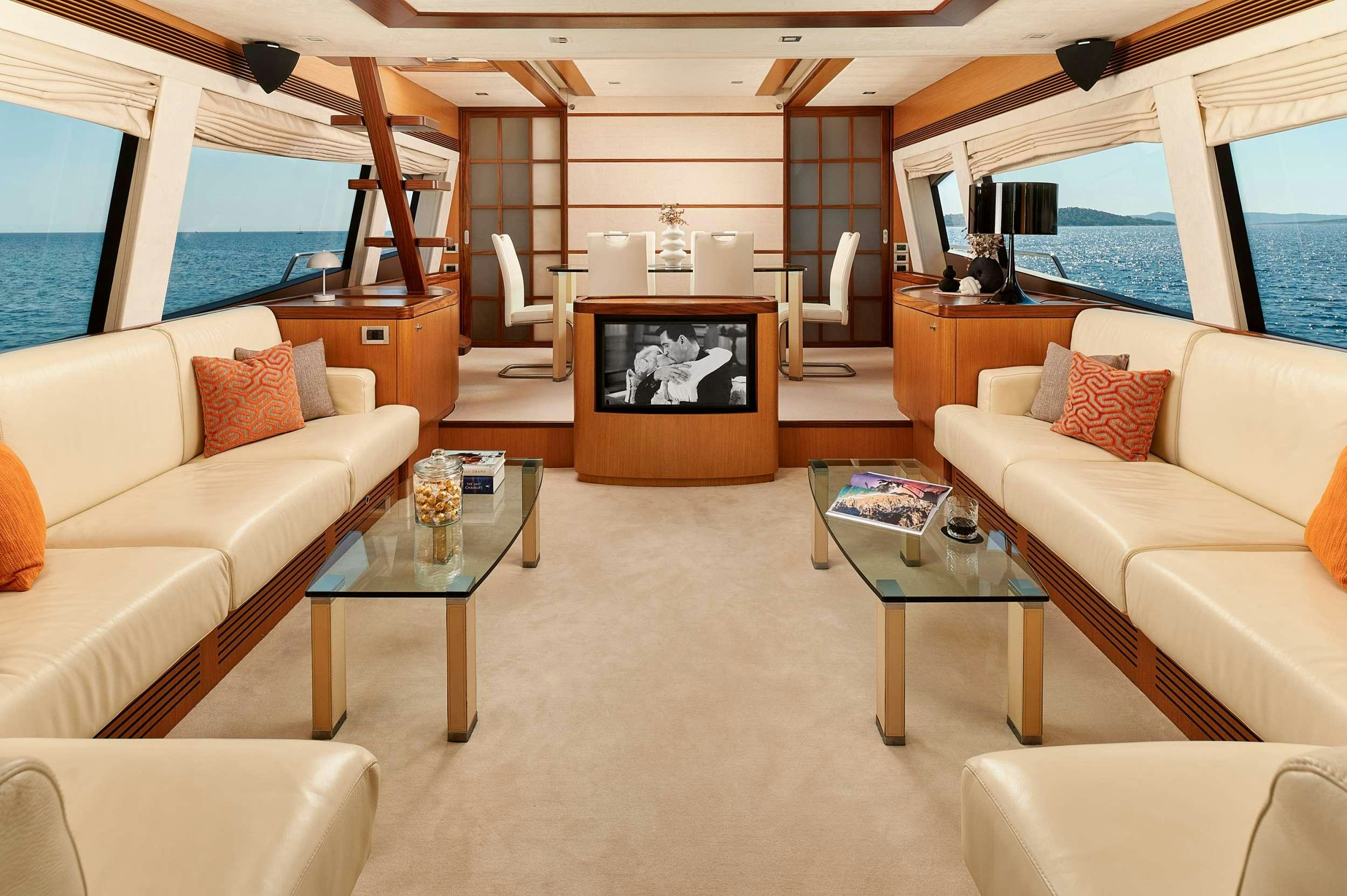 a living room with a large window aboard STELLA D'ORO Yacht for Charter