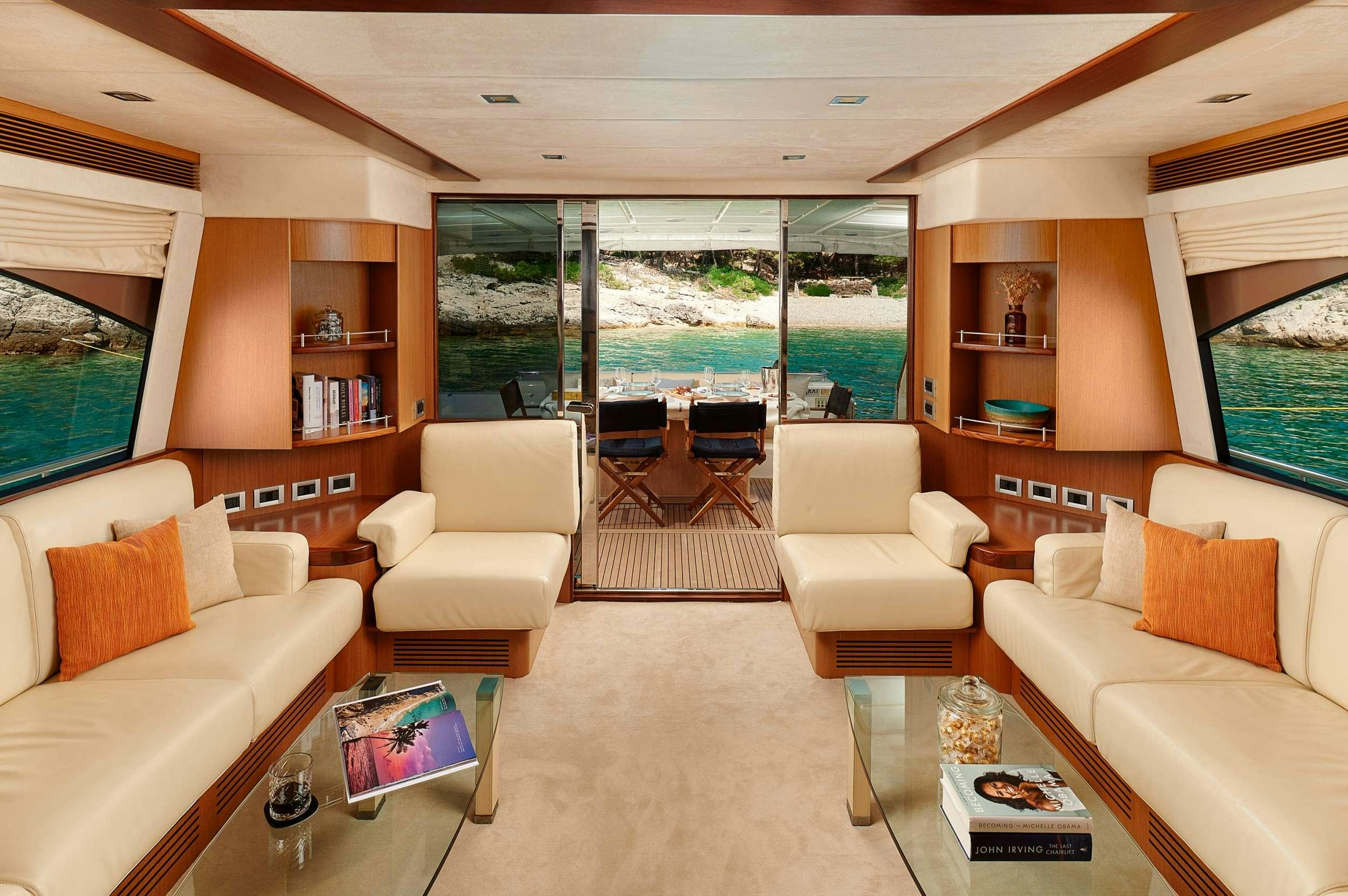 a living room with a large window aboard STELLA D'ORO Yacht for Charter