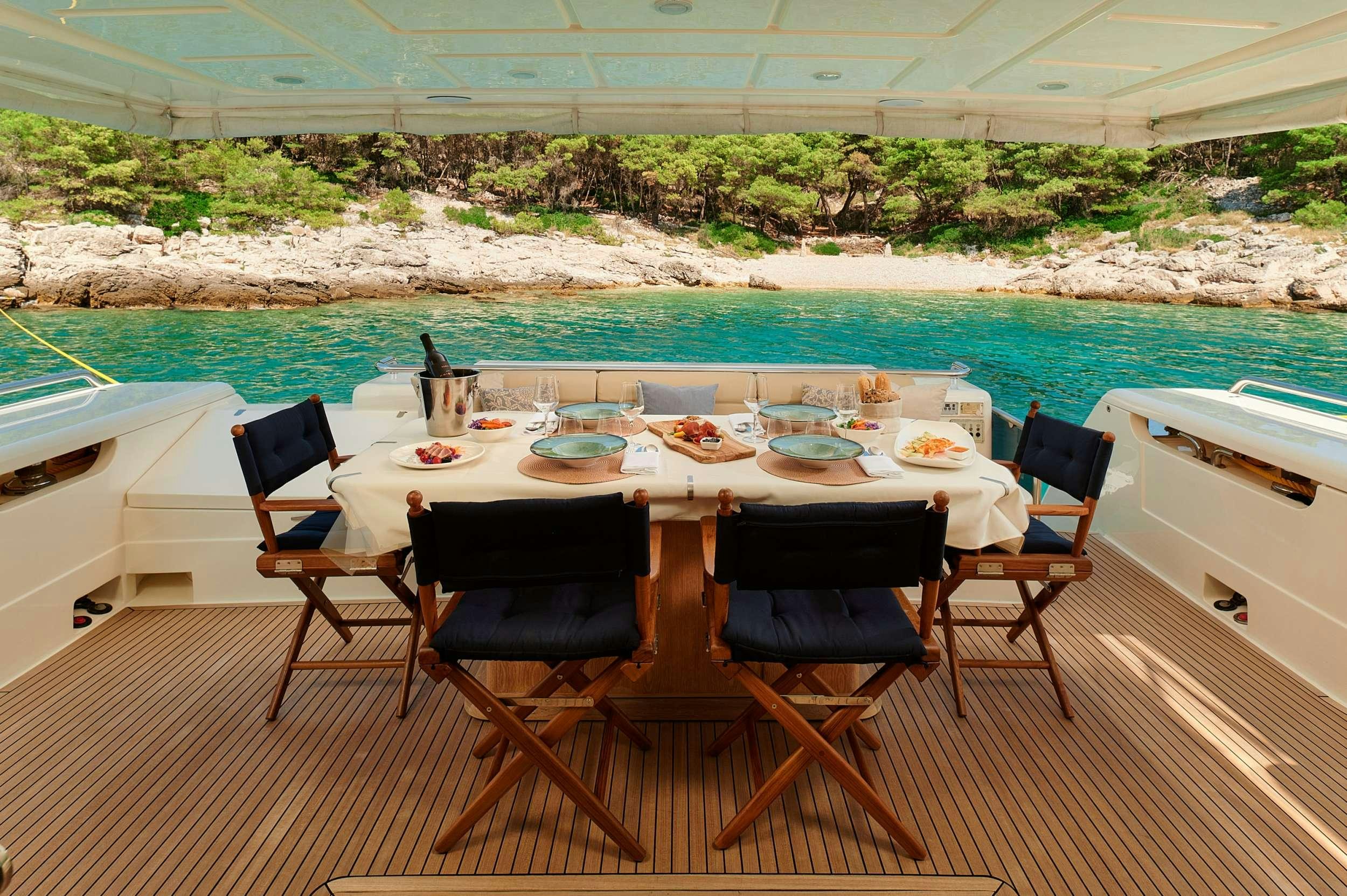 a table set for a meal on a boat aboard STELLA D'ORO Yacht for Charter