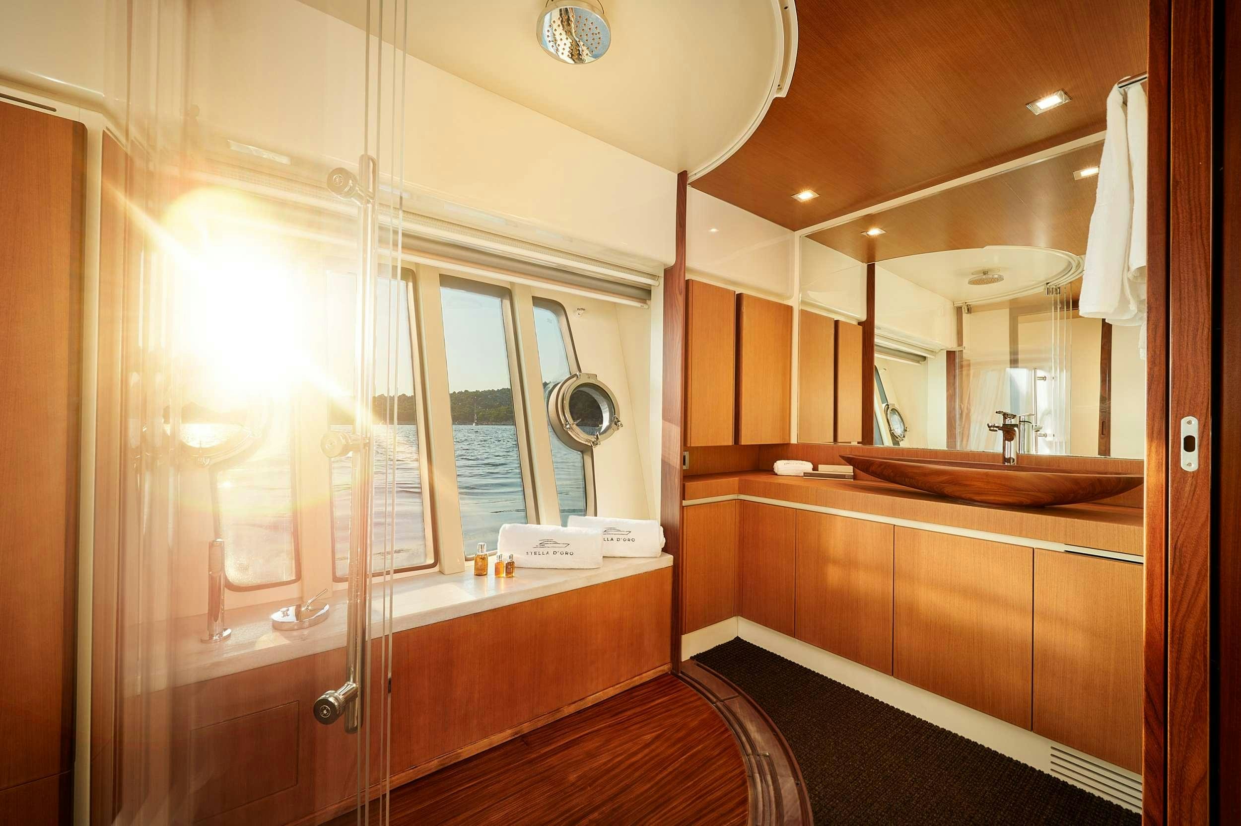 a bathroom with a large mirror aboard STELLA D'ORO Yacht for Charter