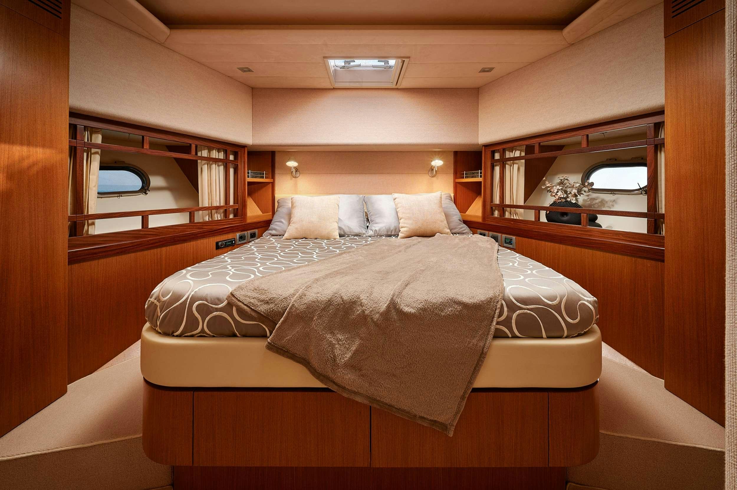 a bed with a mirror above it aboard STELLA D'ORO Yacht for Charter