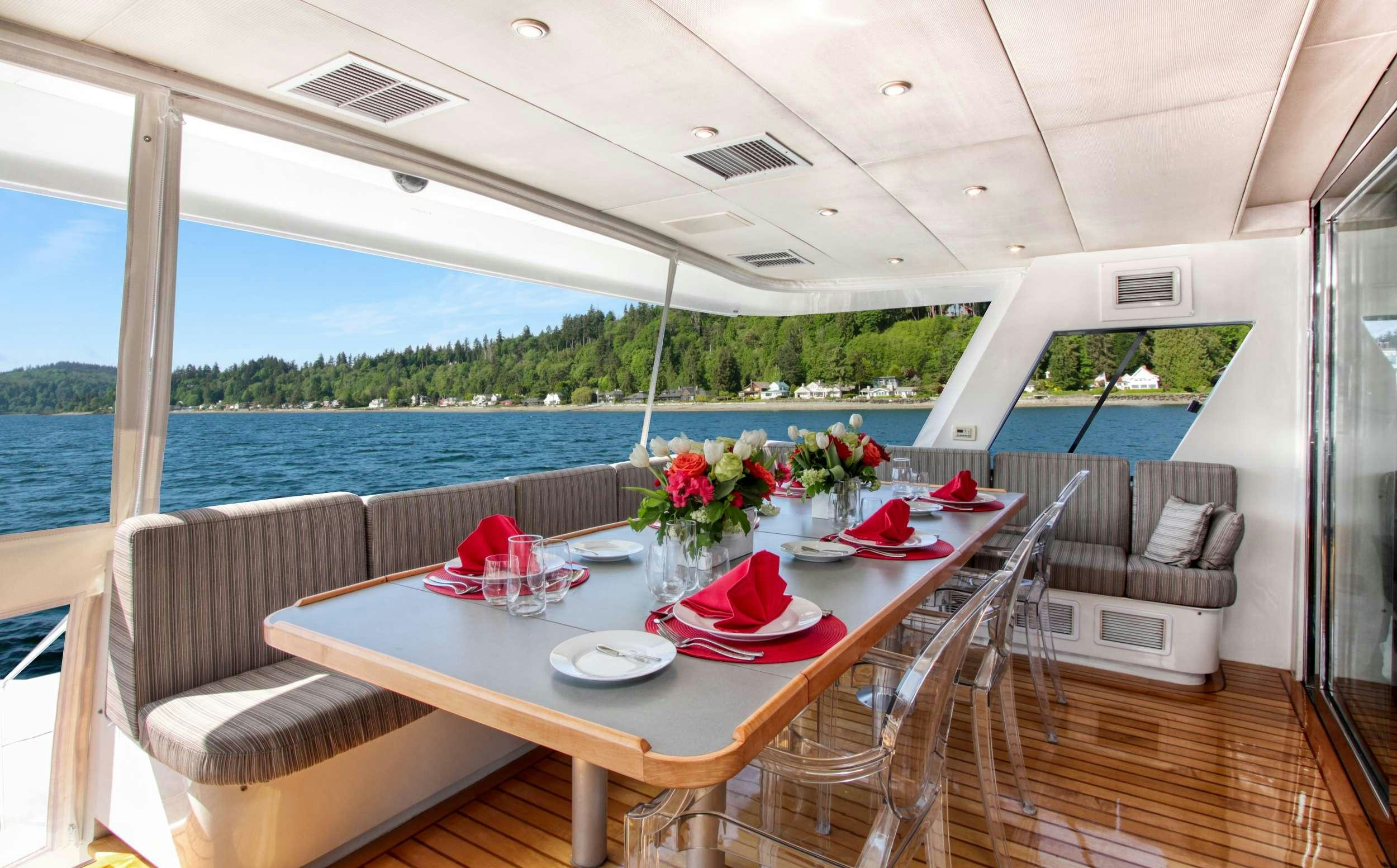 a table on a deck aboard FIRST HOME Yacht for Charter