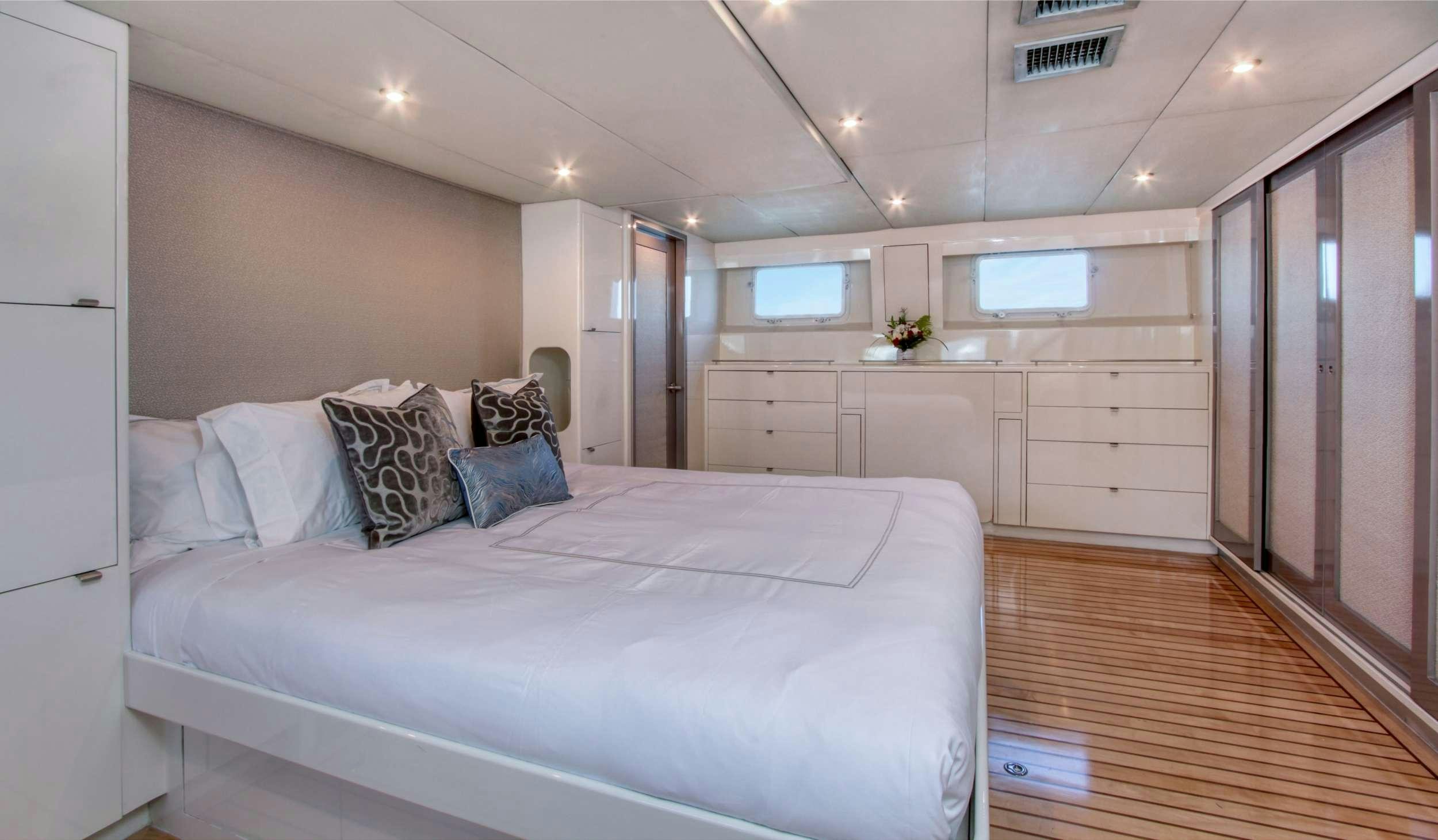 a large white bed in a room aboard FIRST HOME Yacht for Charter