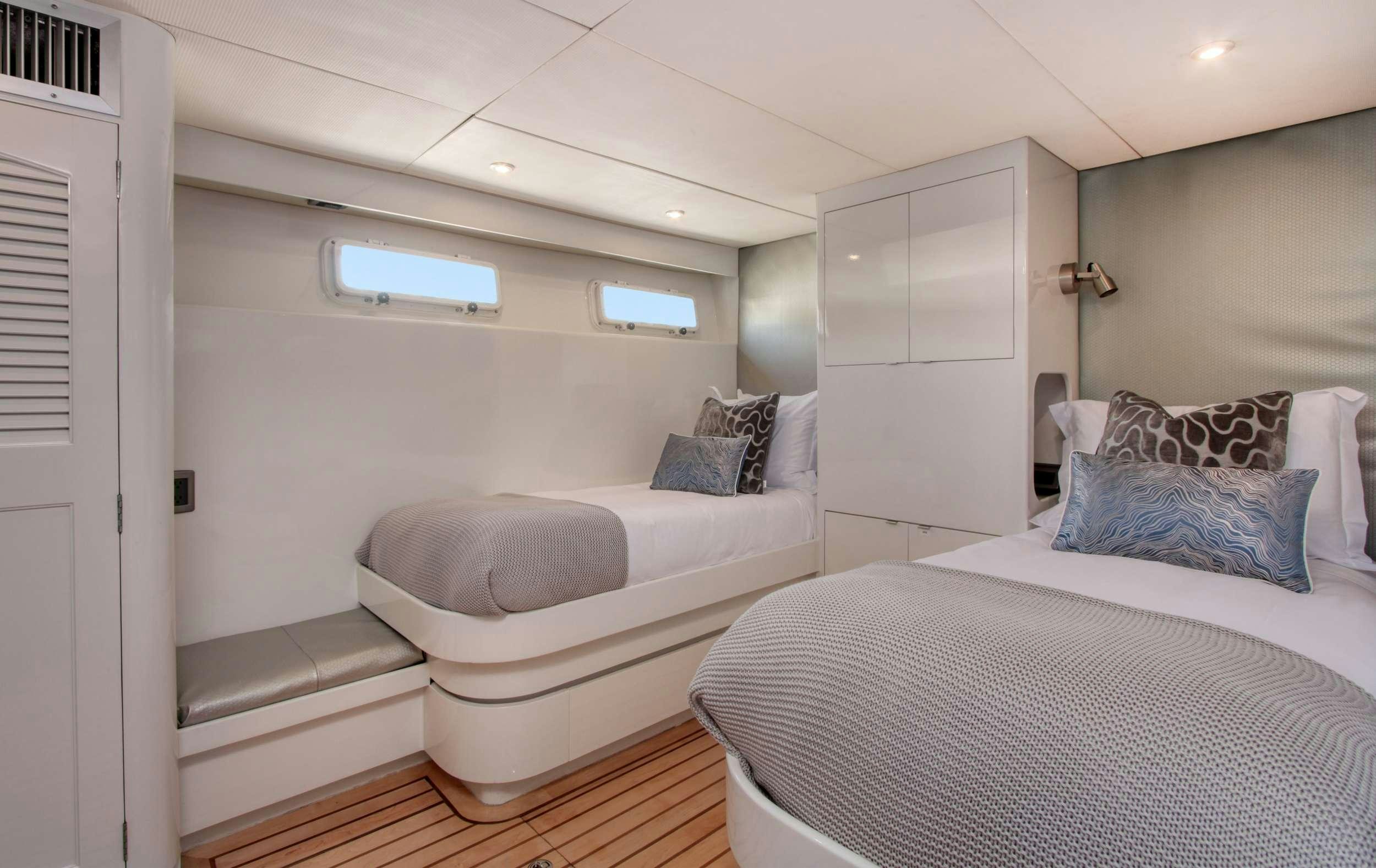 a room with two beds aboard FIRST HOME Yacht for Charter