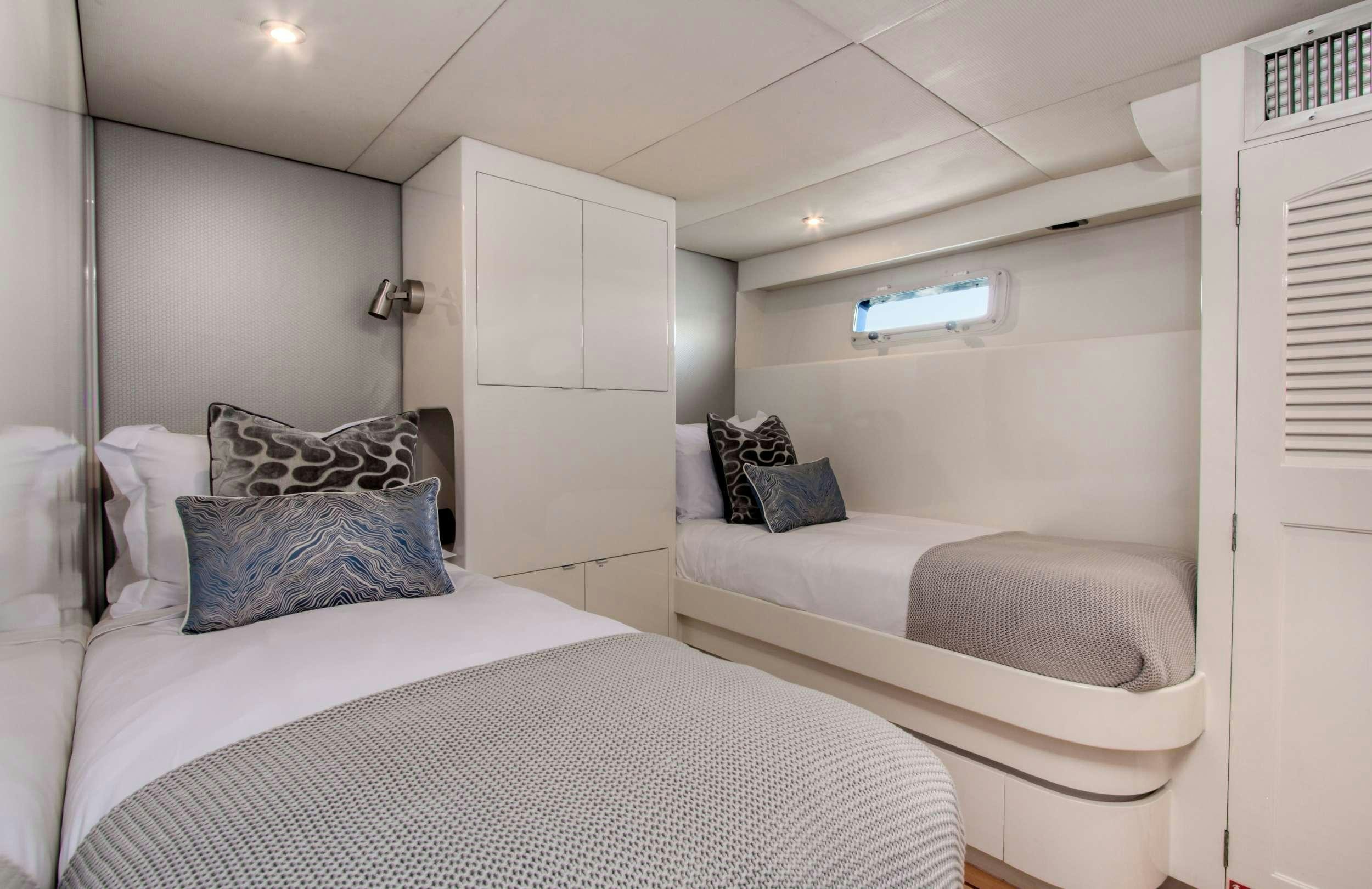 a room with two beds aboard FIRST HOME Yacht for Charter