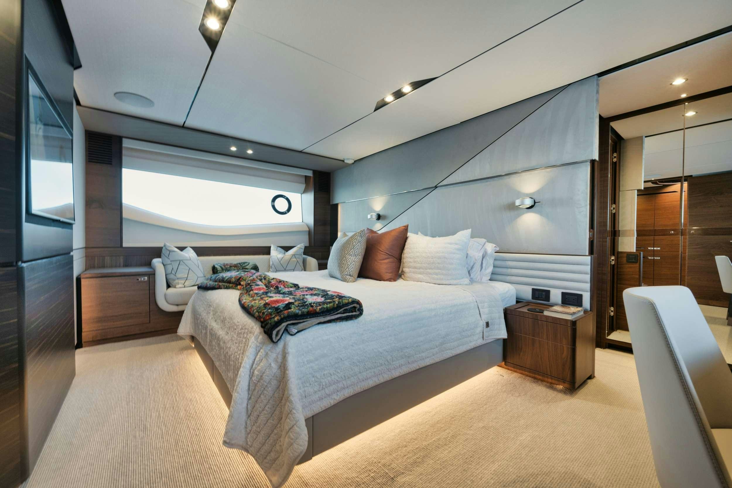 a room with a bed and a window aboard HOOKED HER Yacht for Charter