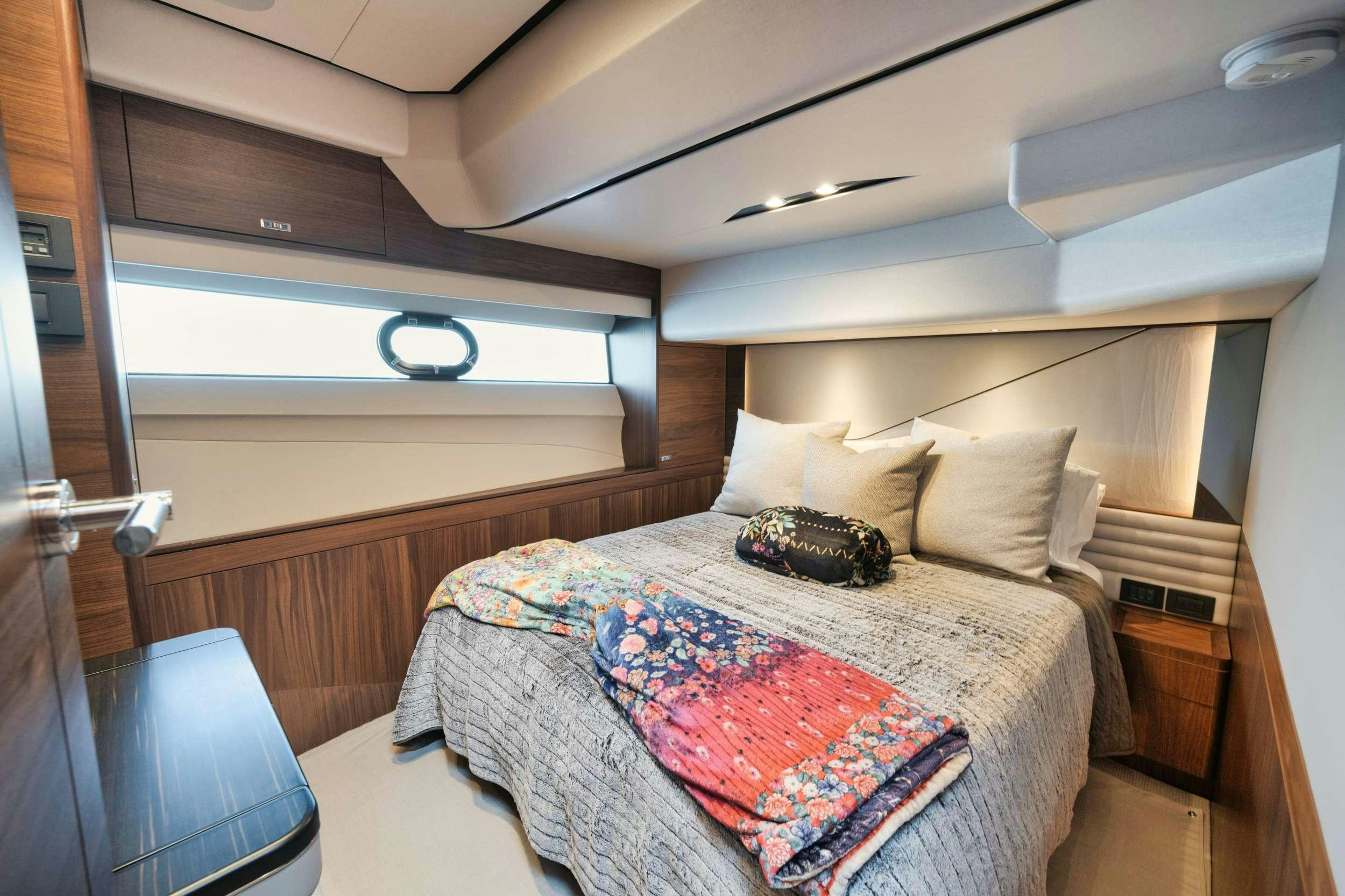 a bed with a pillow on it aboard HOOKED HER Yacht for Charter