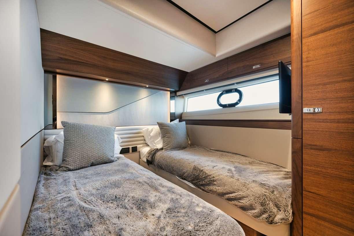 a couple of beds in a room aboard HOOKED HER Yacht for Charter