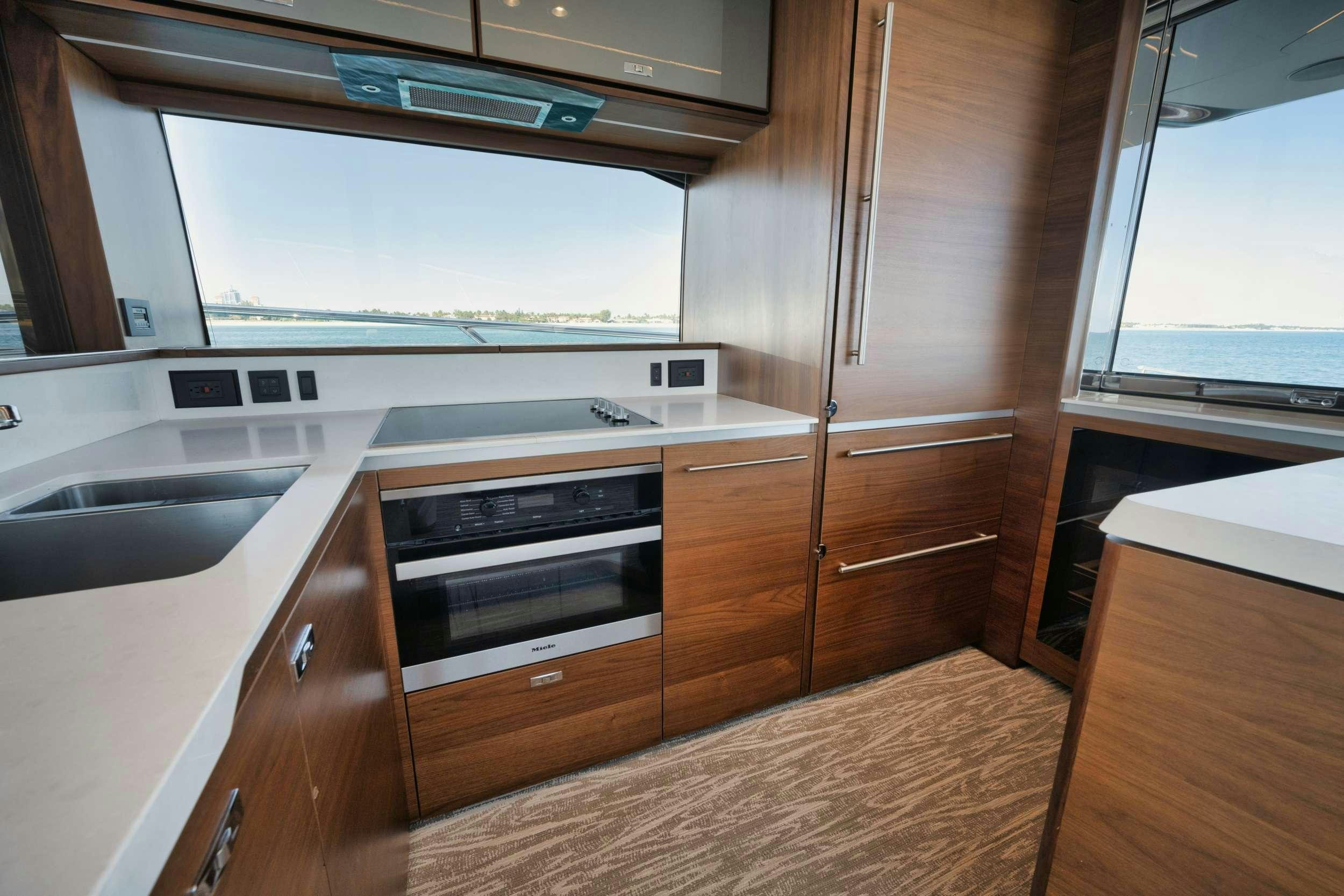 a kitchen with wooden cabinets aboard HOOKED HER Yacht for Charter