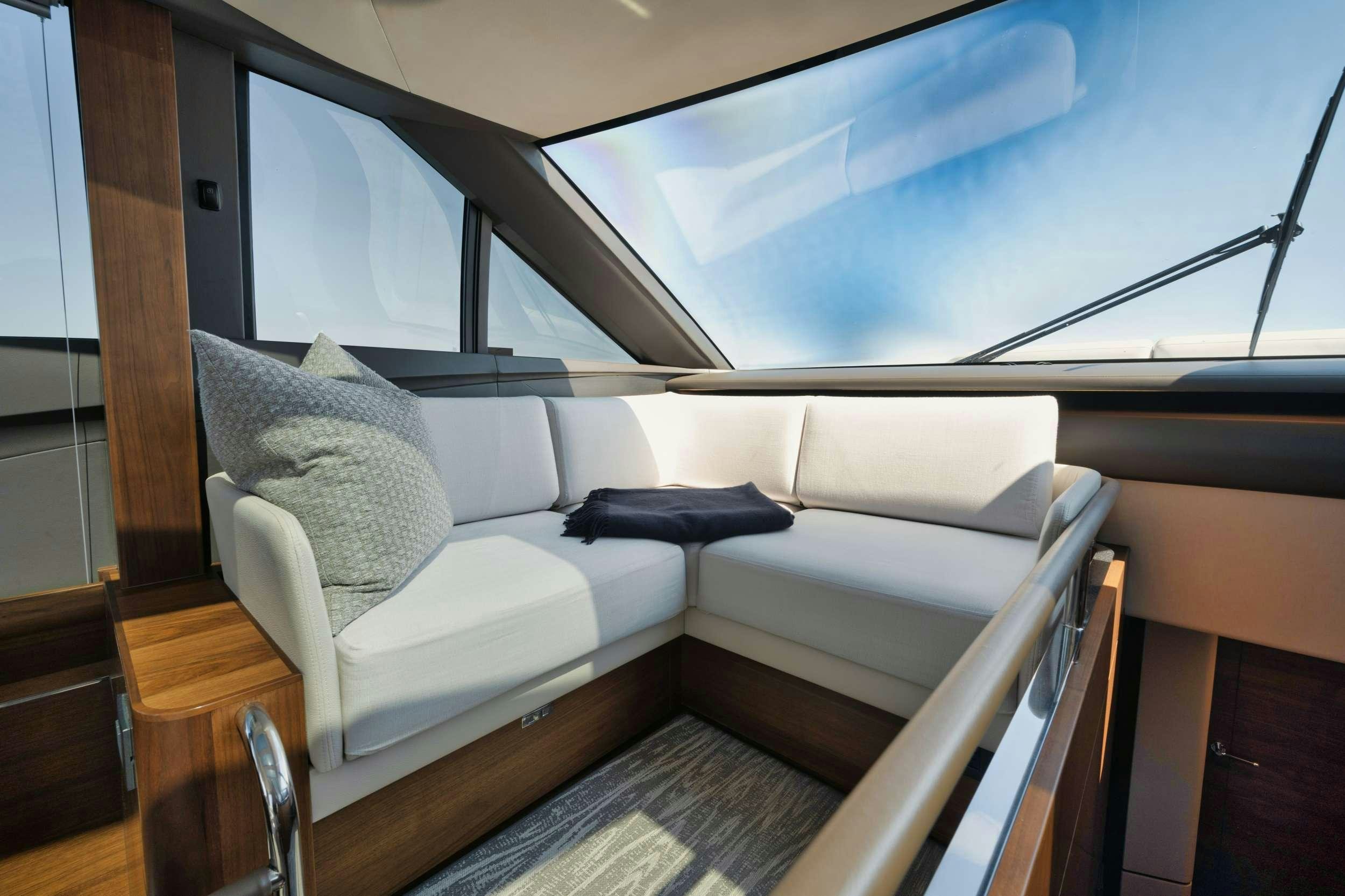 a white couch in a room aboard HOOKED HER Yacht for Charter