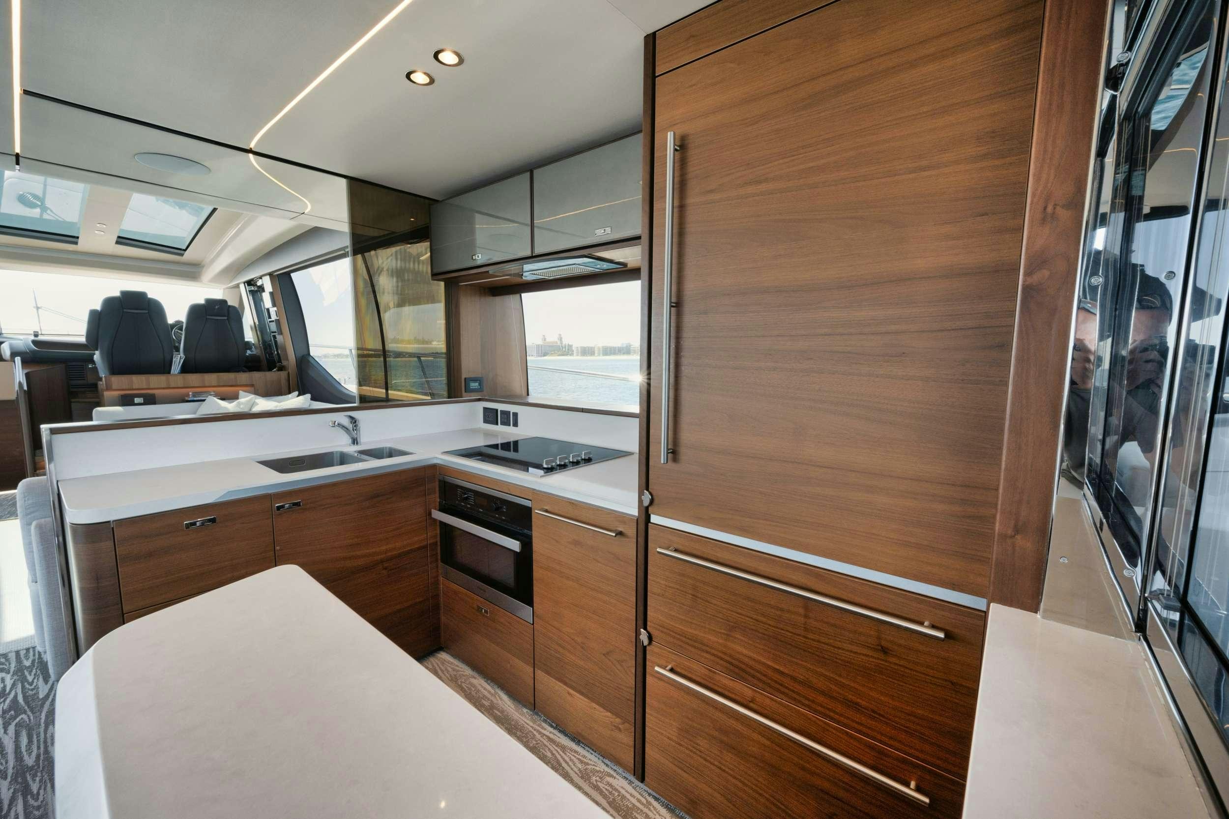 a kitchen with a large wooden door aboard HOOKED HER Yacht for Charter