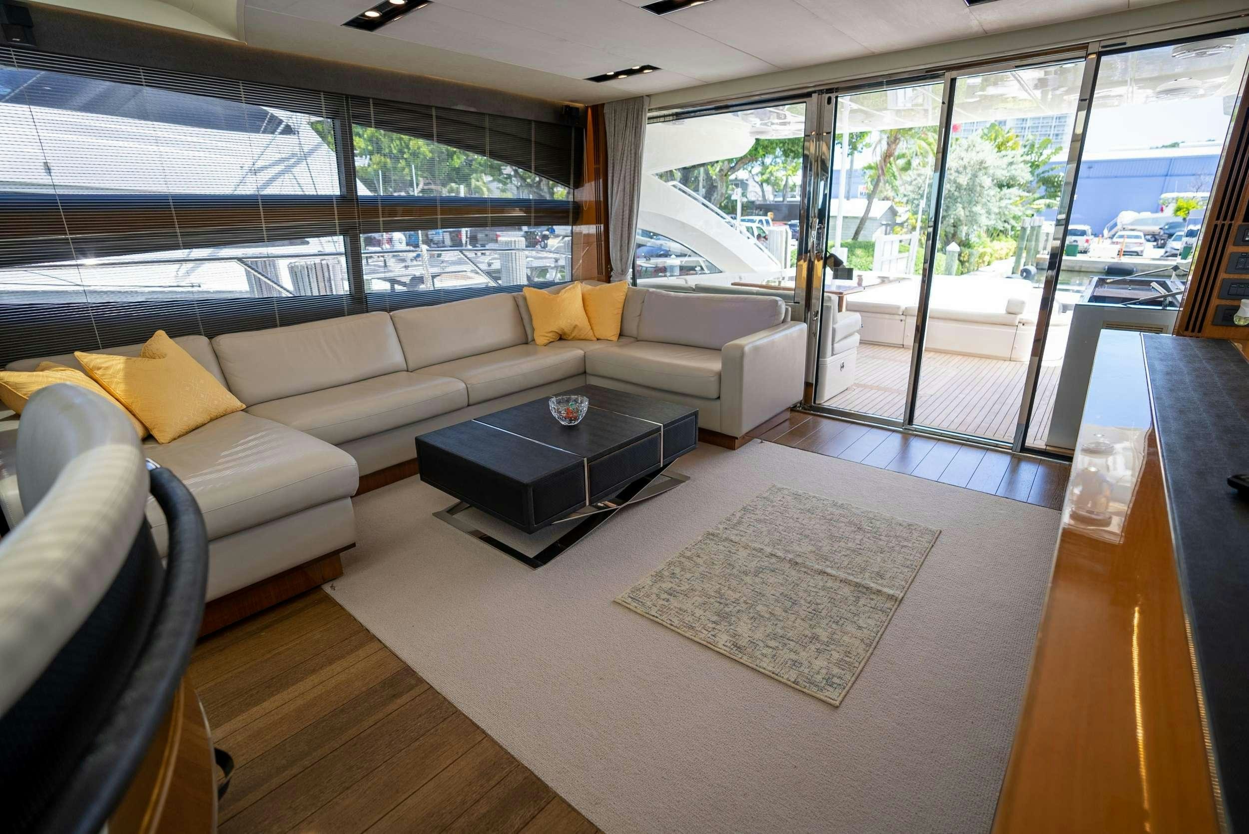 a living room with a large window aboard POLICY LIMITS Yacht for Charter