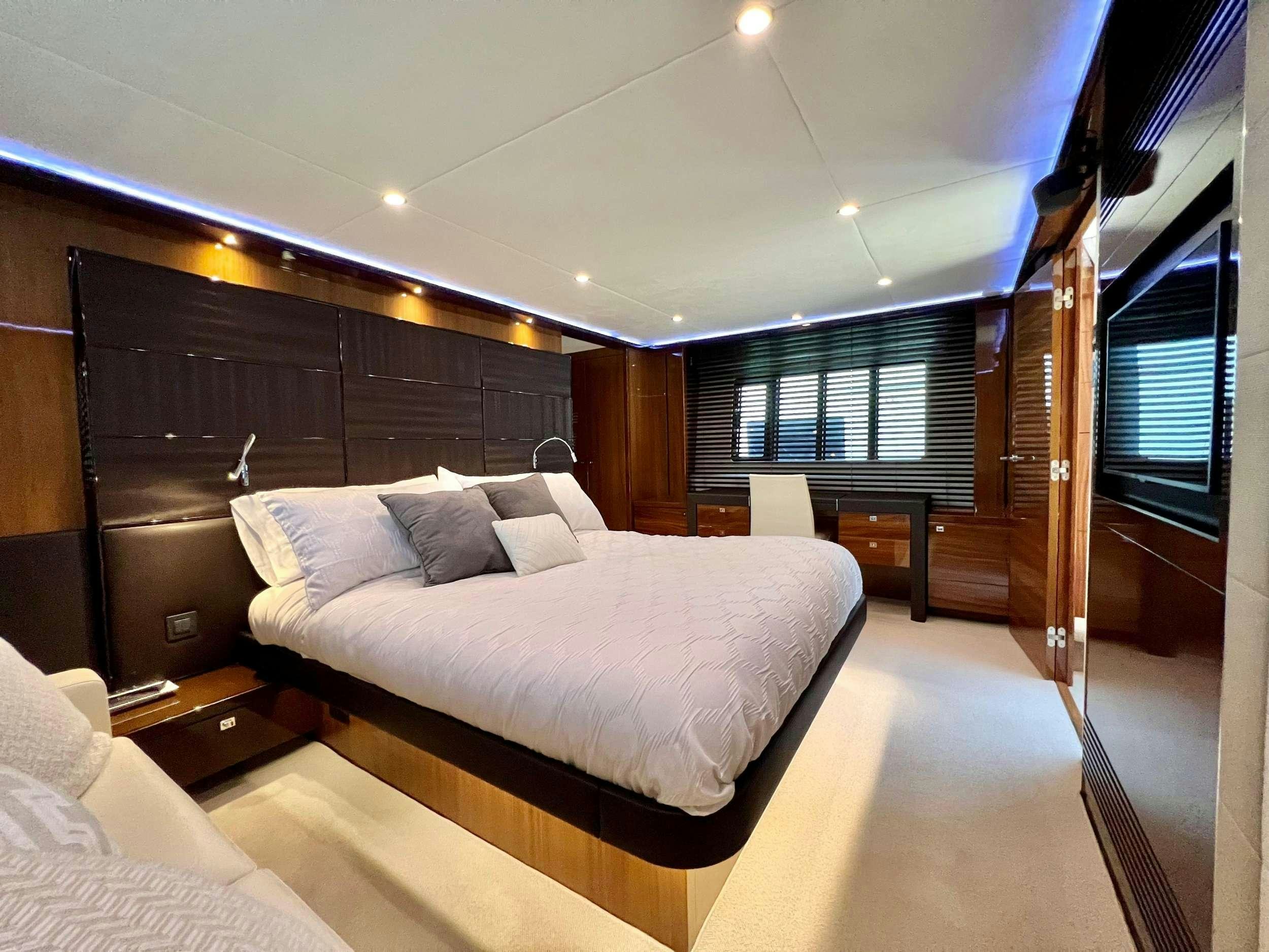 a room with a bed and a large mirror aboard POLICY LIMITS Yacht for Charter