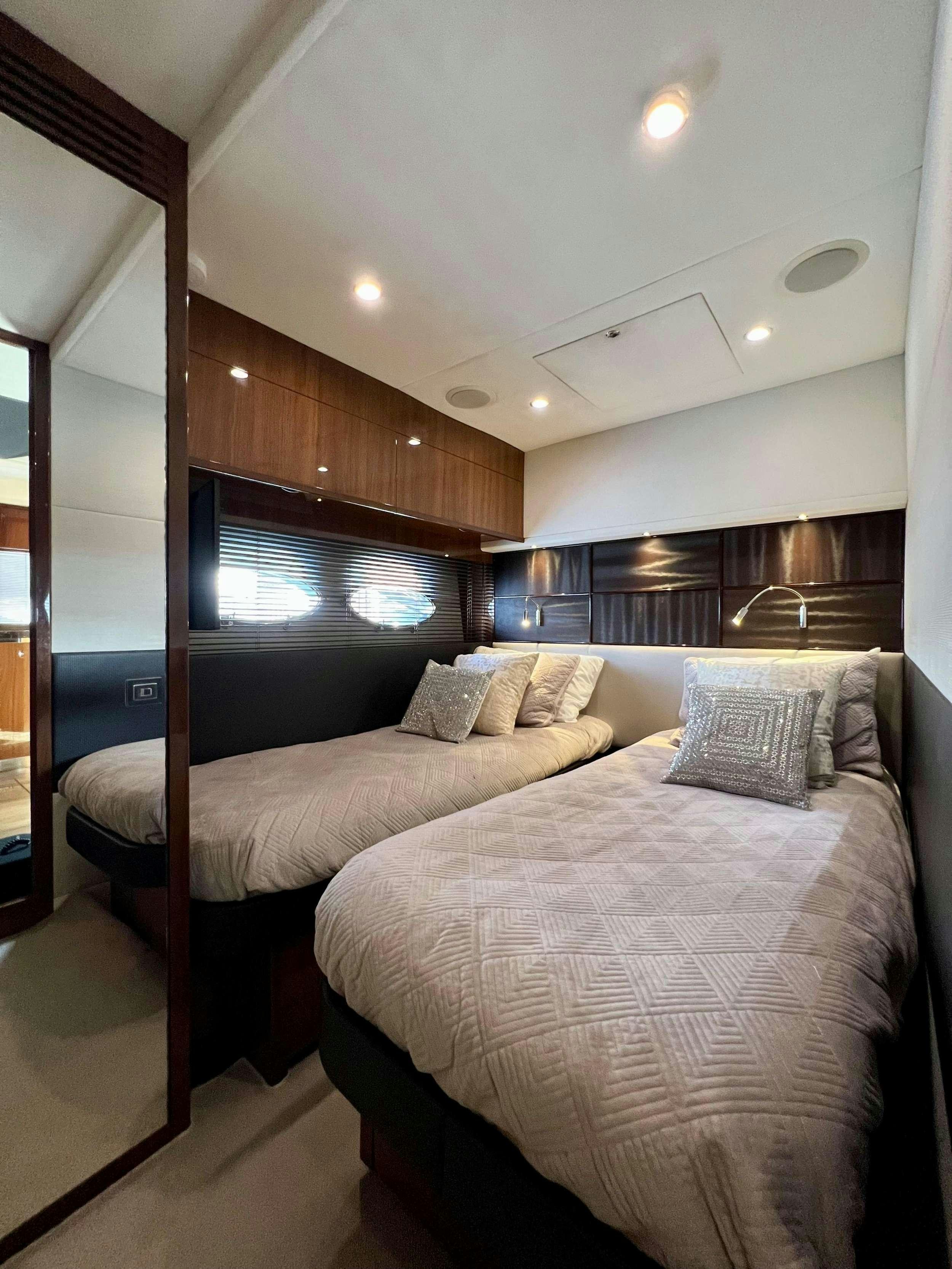 a bed with a wood headboard aboard POLICY LIMITS Yacht for Charter