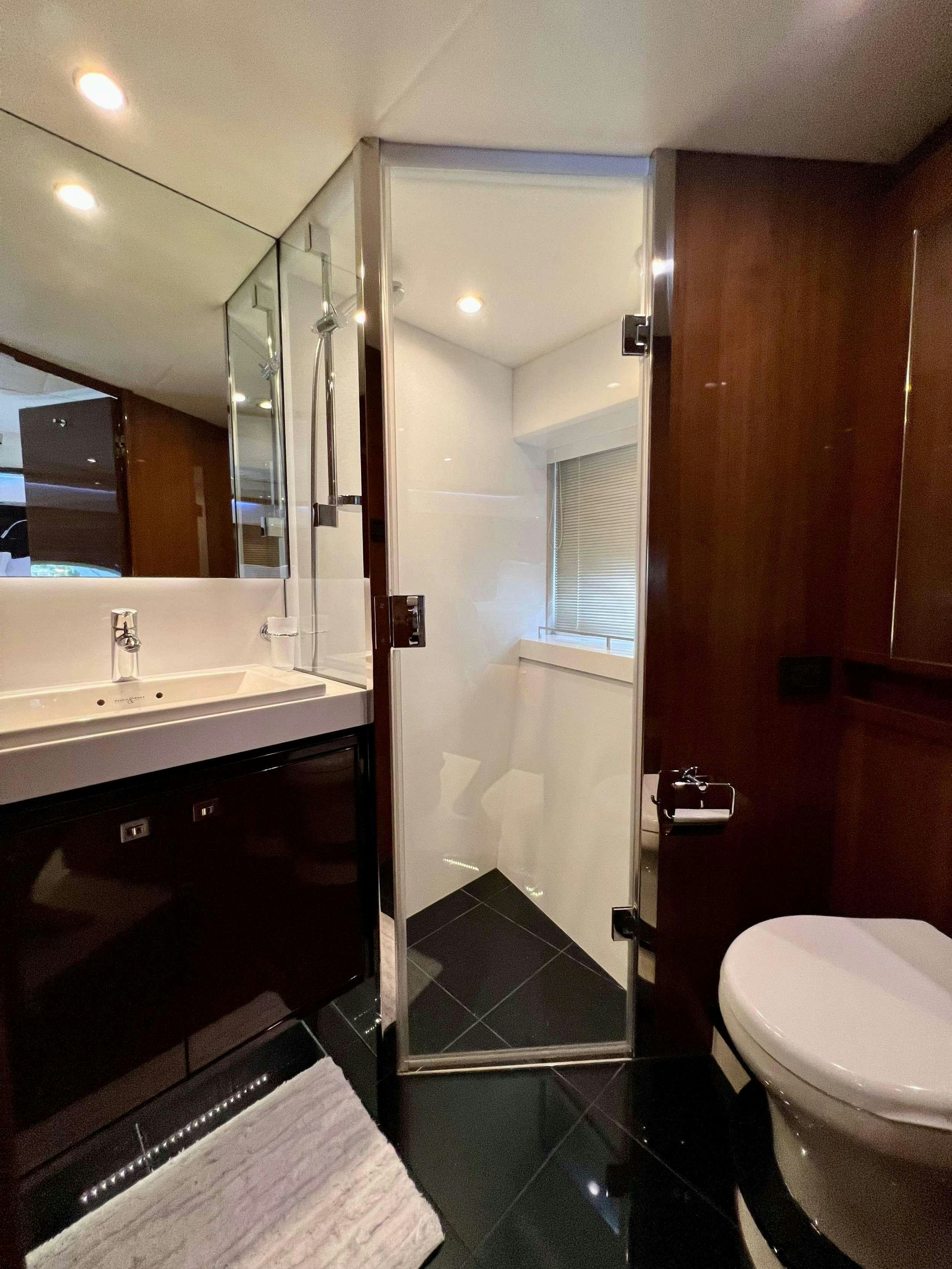 a bathroom with a glass shower aboard POLICY LIMITS Yacht for Charter