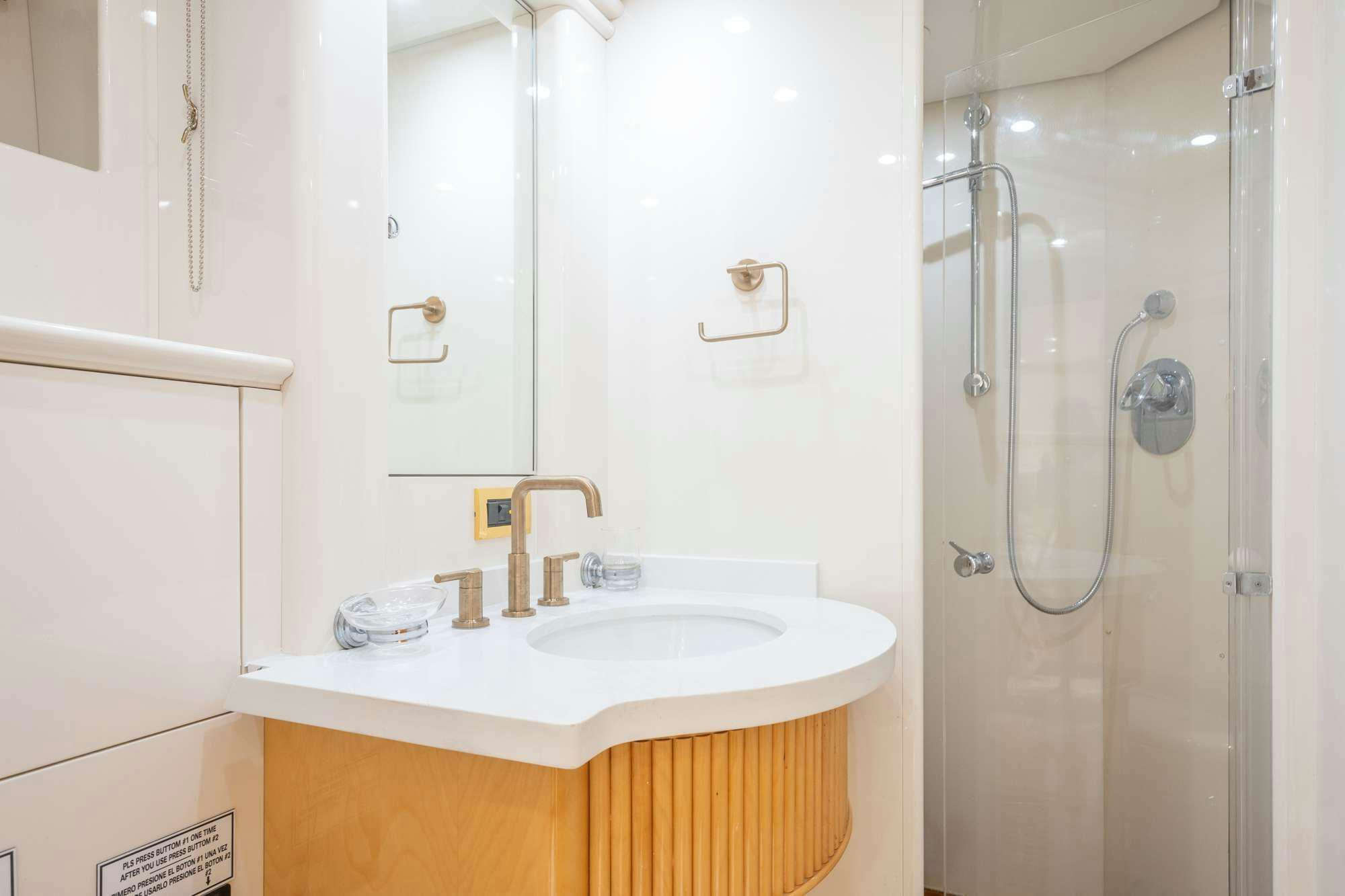 a bathroom with a shower sink and a mirror aboard STEELING TIME Yacht for Charter