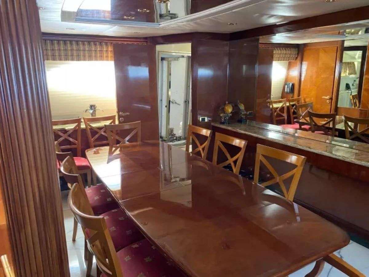a room with tables and chairs aboard STEELING TIME Yacht for Charter