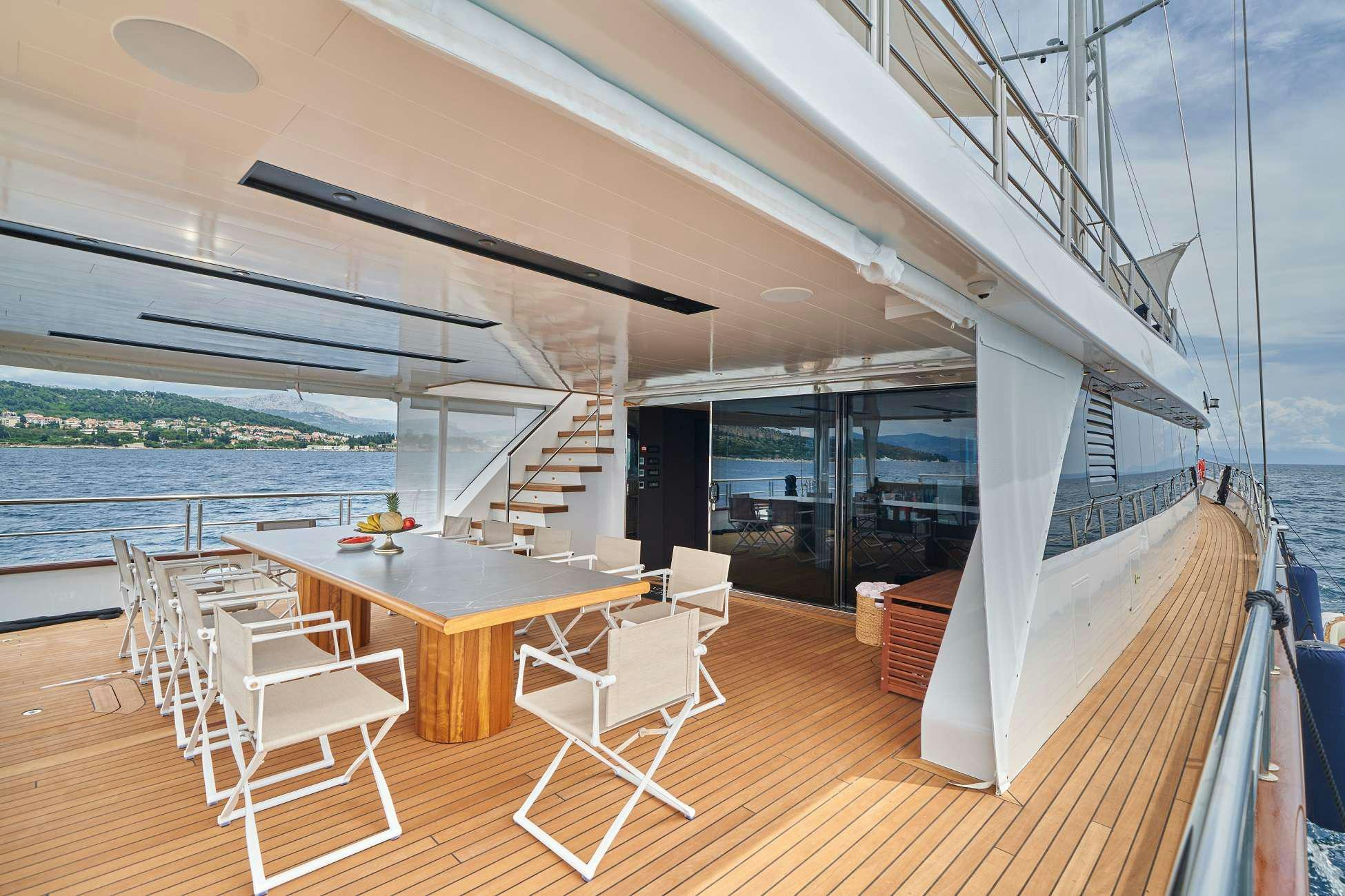 a room with a table and chairs aboard MARALLURE Yacht for Charter