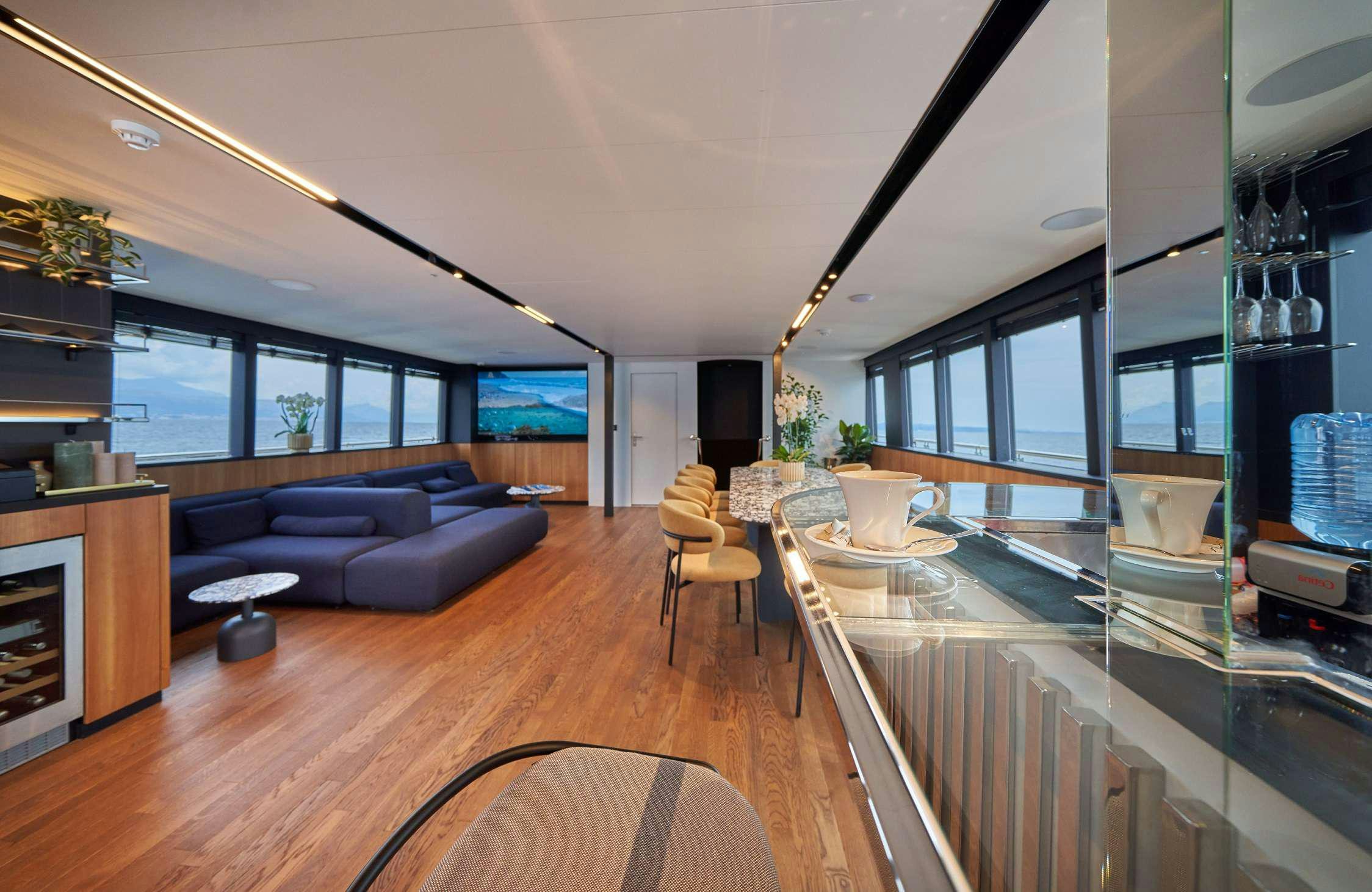 a large living room with a wood floor aboard MARALLURE Yacht for Charter
