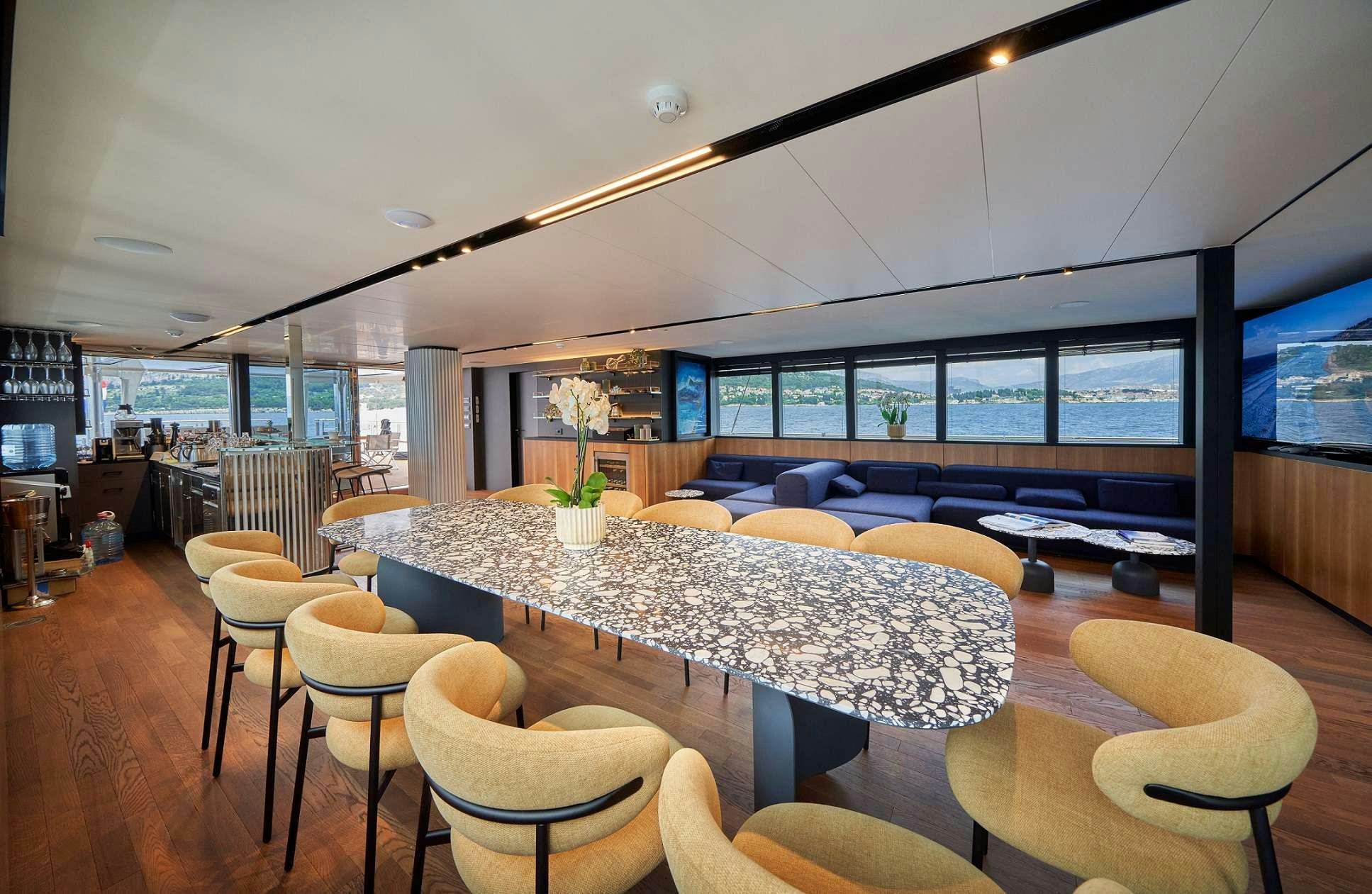 a room with a table and chairs aboard MARALLURE Yacht for Charter