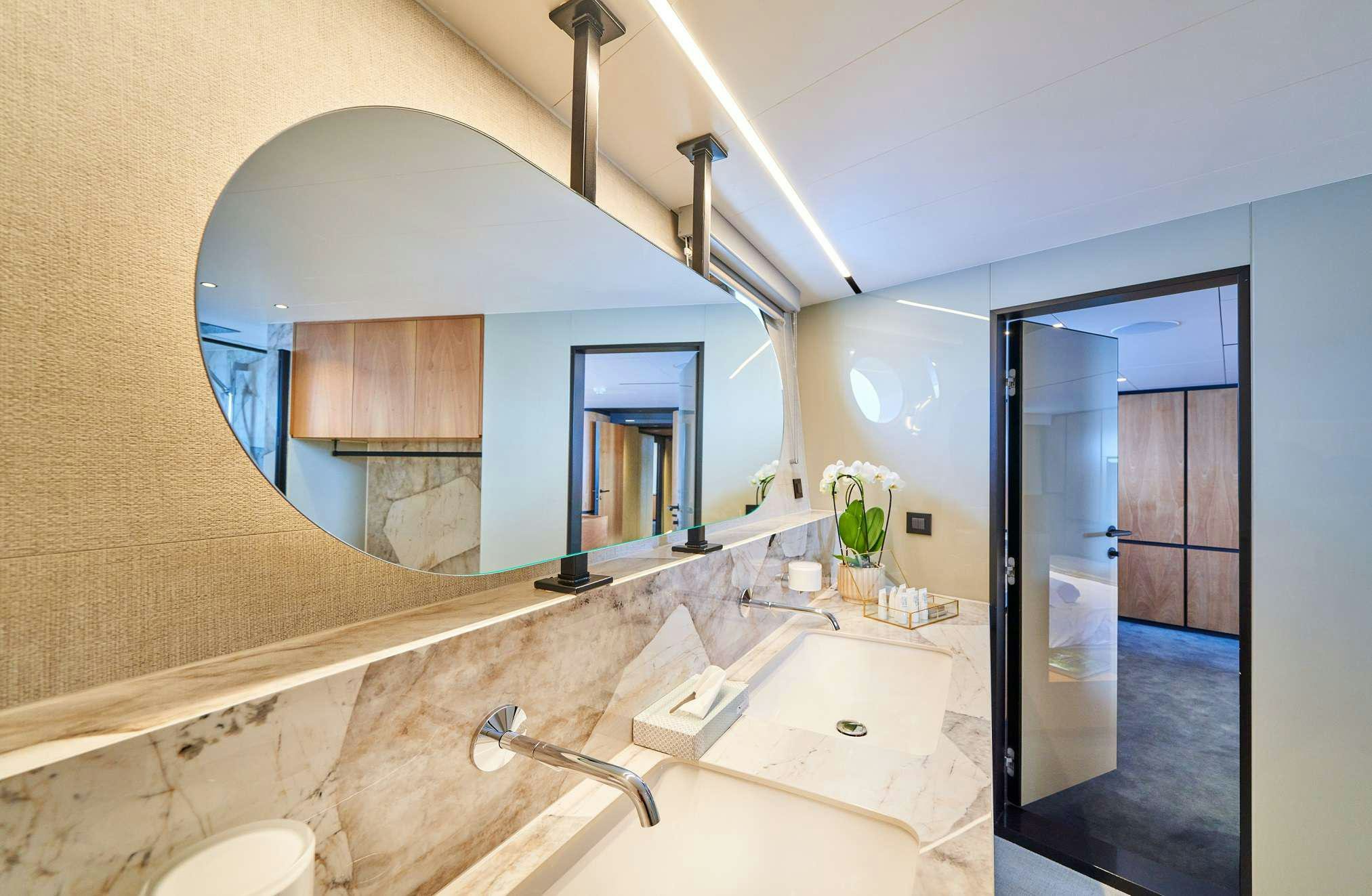 a bathroom with a large mirror aboard MARALLURE Yacht for Charter