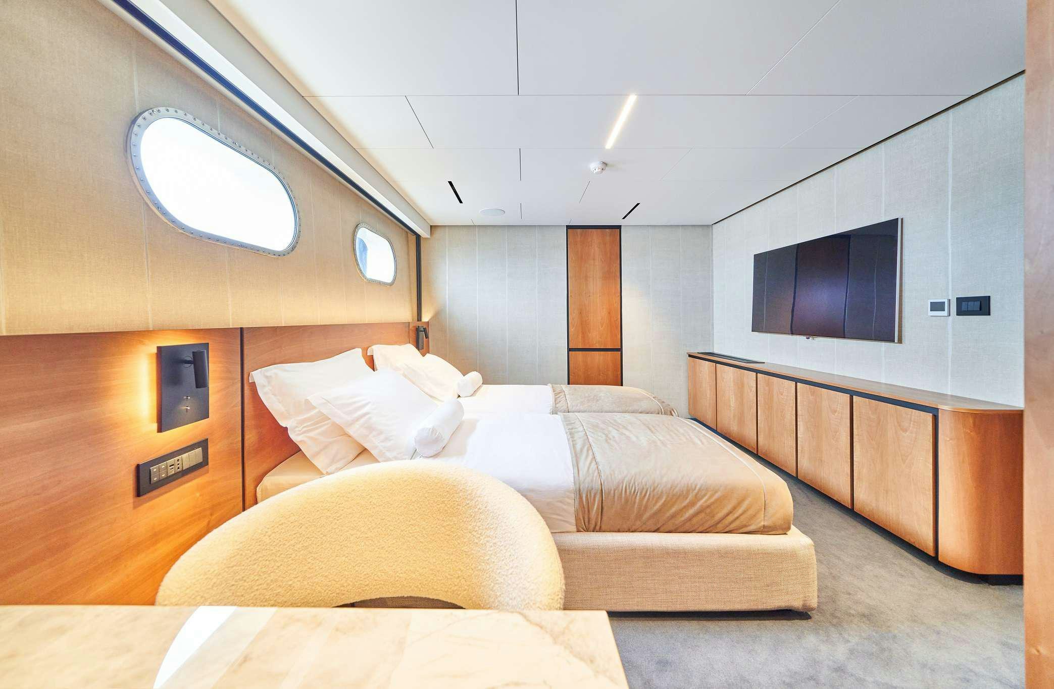a room with a bed and a tv aboard MARALLURE Yacht for Charter