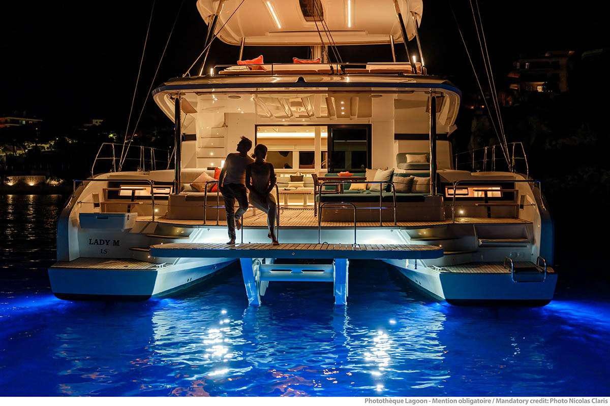 a couple of people standing on a boat in the water aboard VALINOR Yacht for Charter
