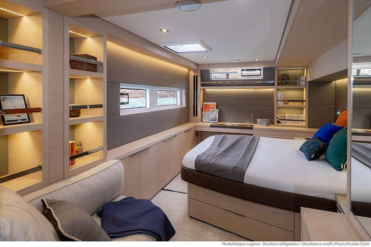 a room with a bed and a desk aboard VALINOR Yacht for Charter