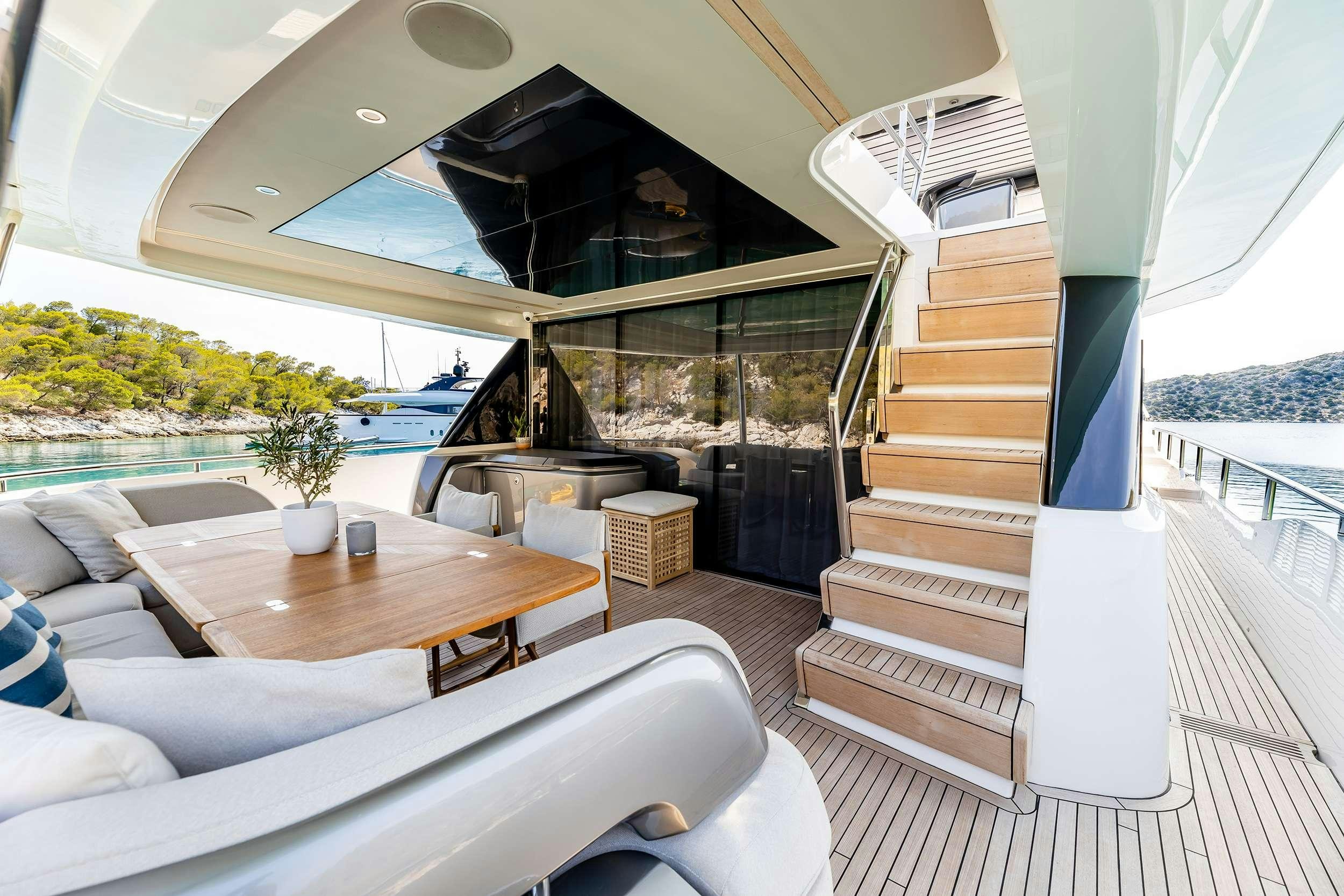 a room with a table and a couch aboard VISTA Yacht for Charter