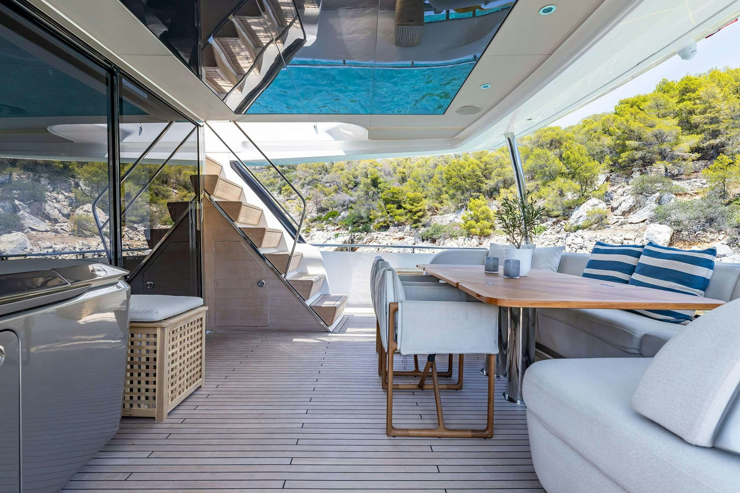 a room with a table and chairs aboard VISTA Yacht for Charter