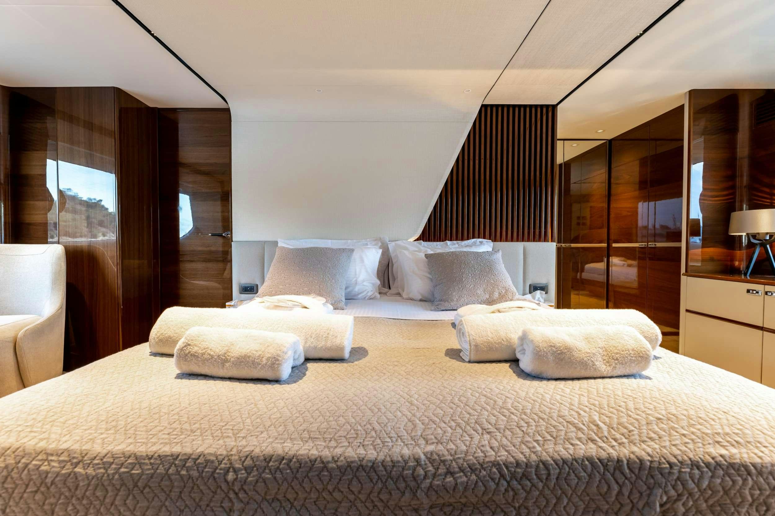 a bed with white sheets aboard VISTA Yacht for Charter
