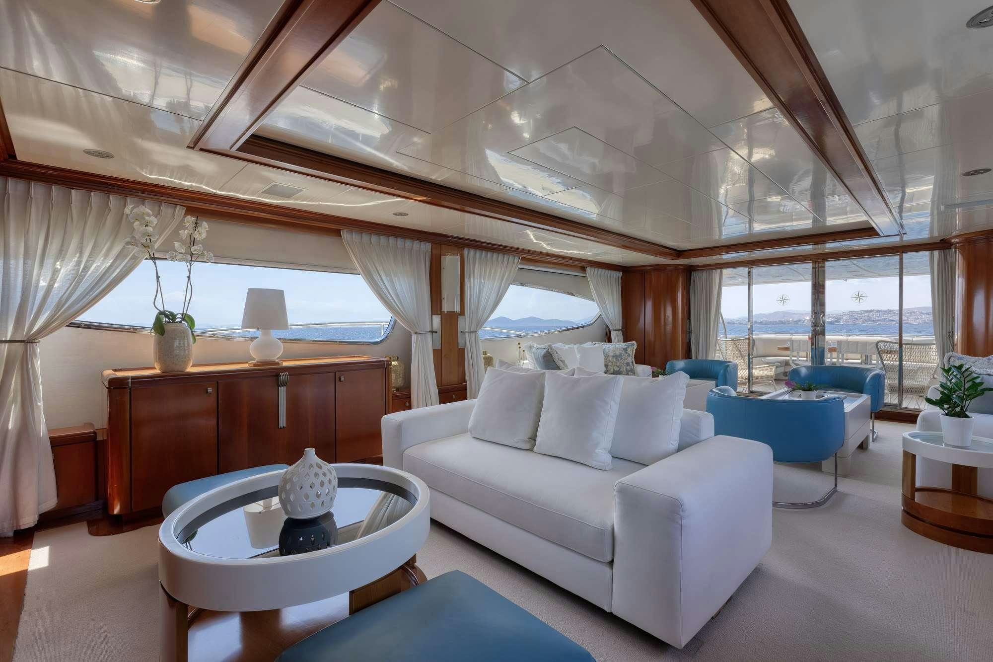a living room with a large window aboard WHY Yacht for Charter