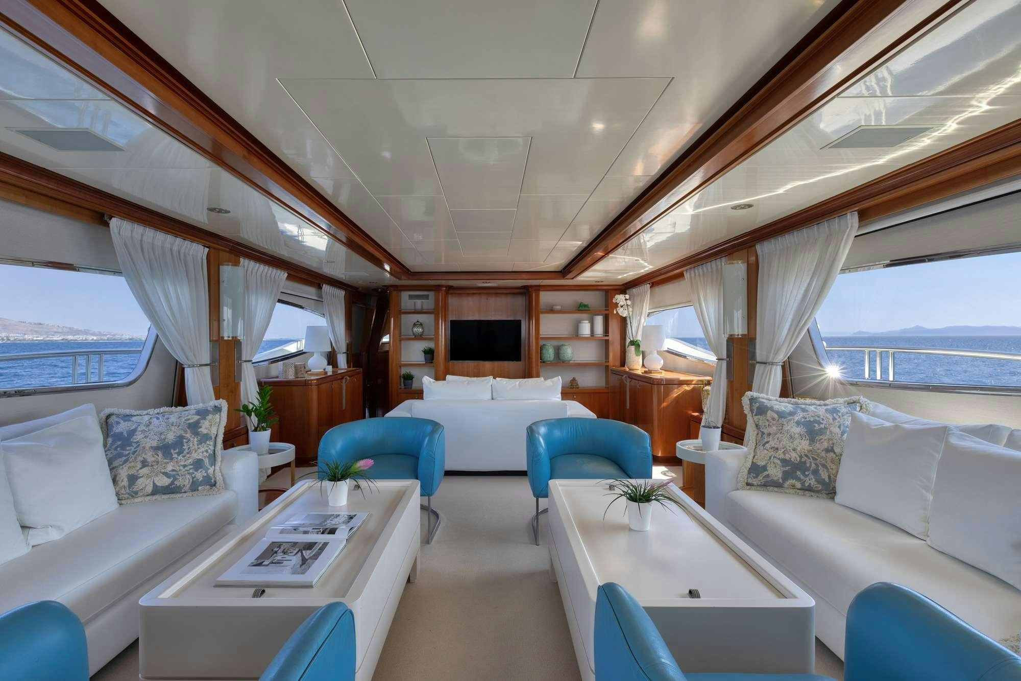 a room with a couch and a table and a bed aboard WHY Yacht for Charter